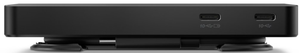 Un dispositivo negro, con puertos USB-C, encima de dos ventosas. Fondo blanco.