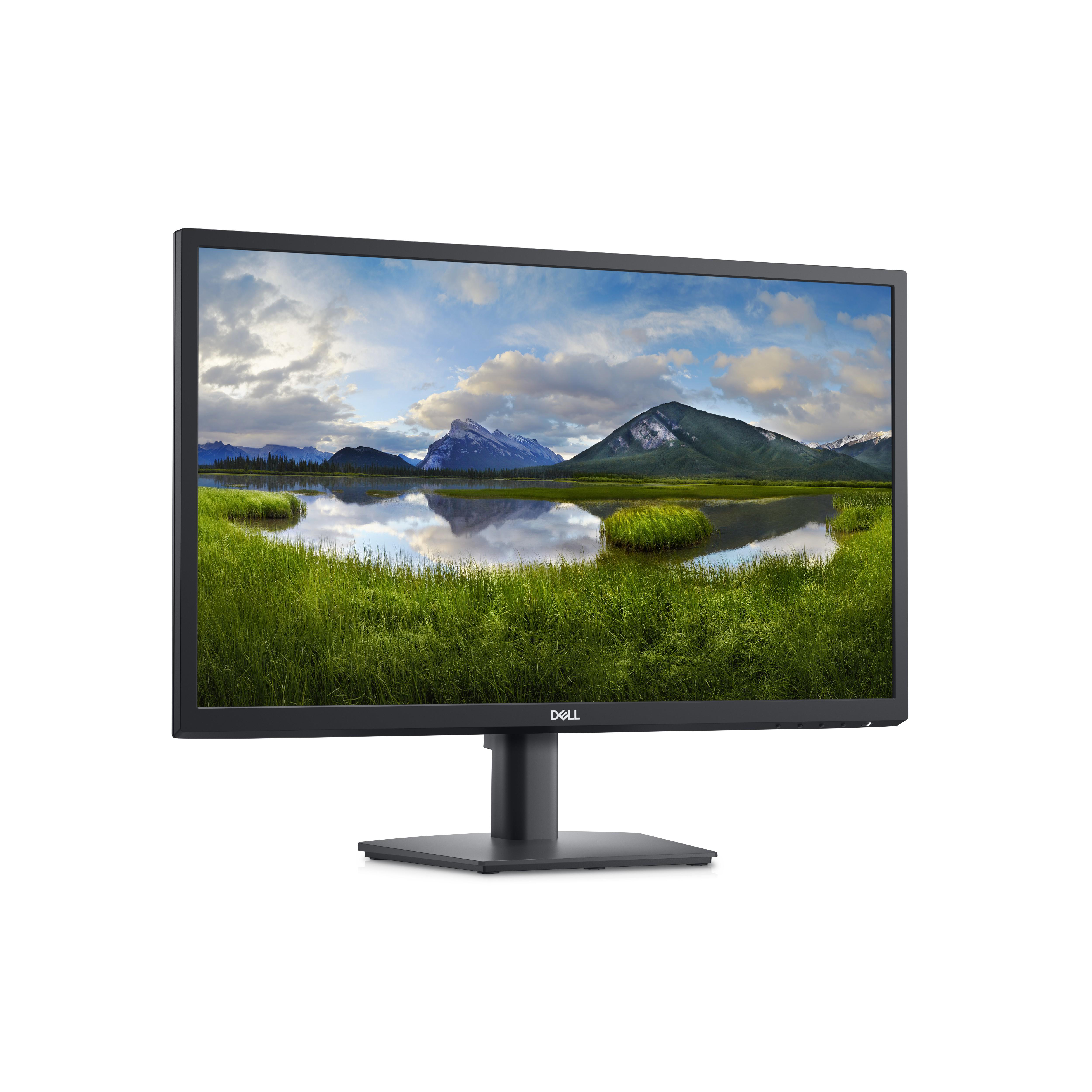 Computermonitor zeigt Landschaft mit Bergen und See, auf einem Schreibtisch.