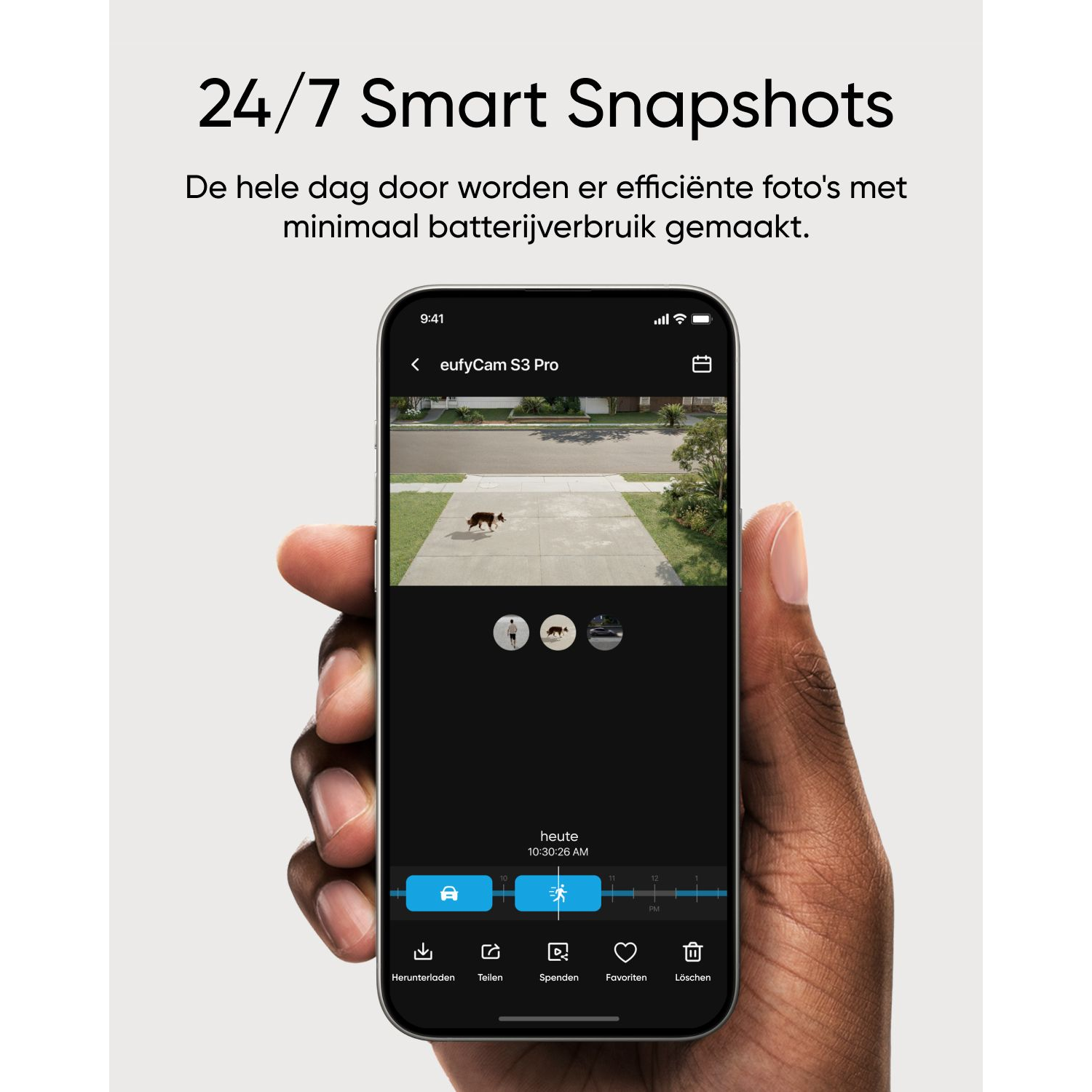 Person's hand holding a smartphone displaying a home security app, with dog in the yard.