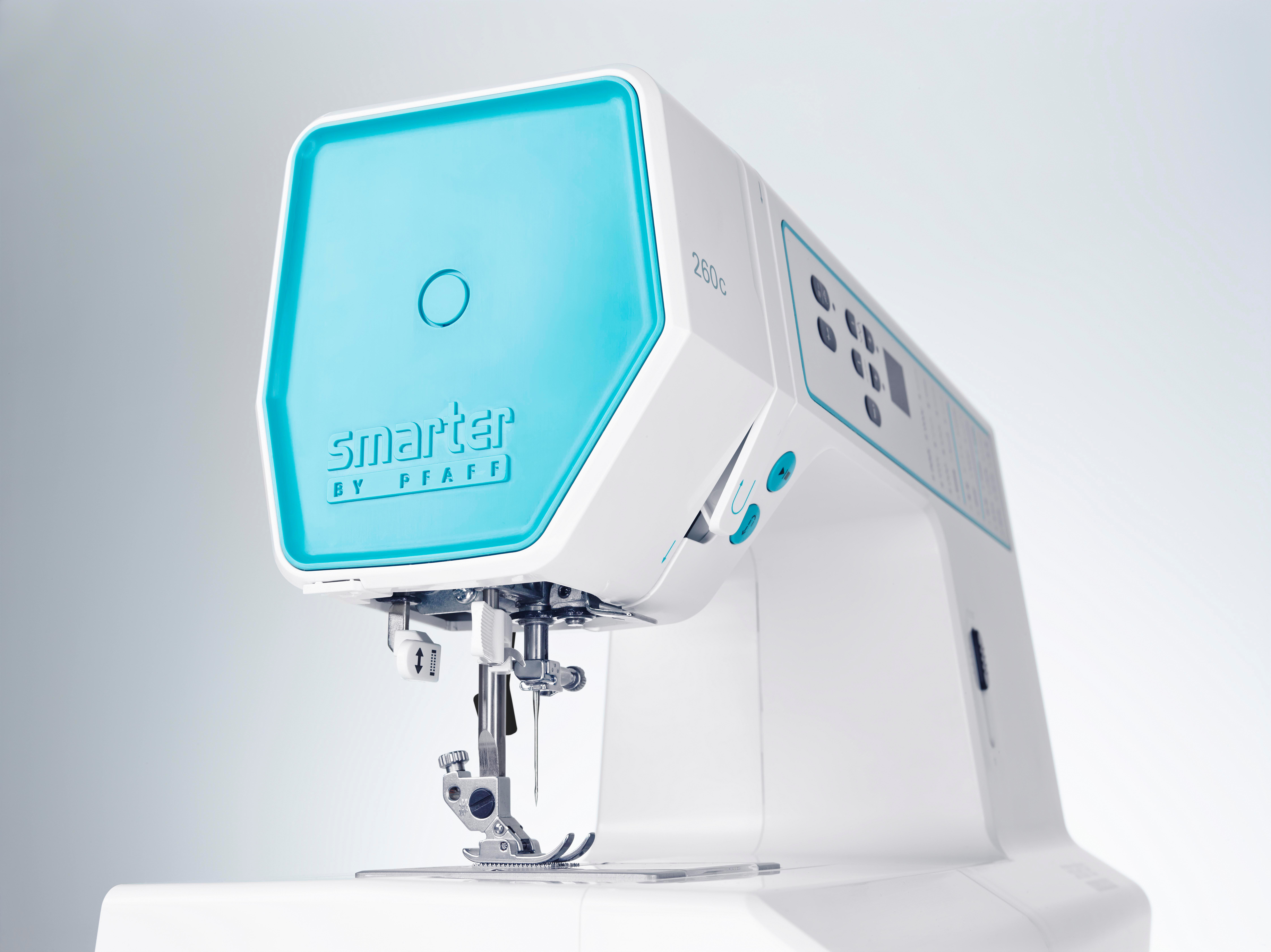 Weiße Nähmaschine mit türkisfarbenem Oberteil, Markenname Smarter by Pfaff.