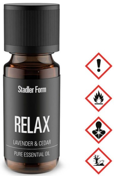 Brązowa butelka olejku eterycznego z ikonami ostrzegawczymi obok.