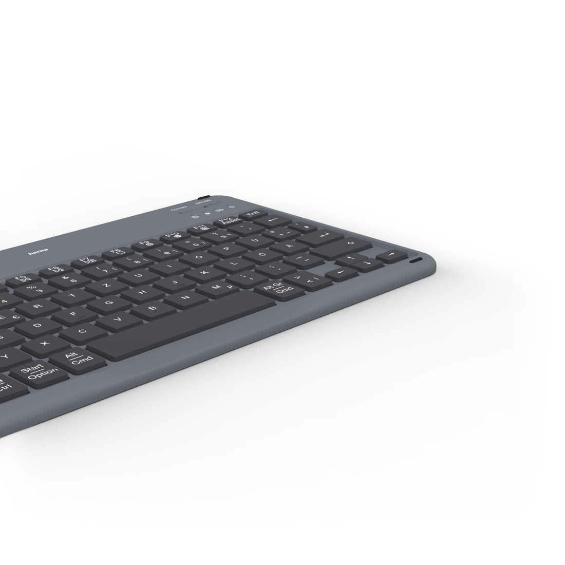 Graue Tastatur auf weißer Oberfläche. Die Tasten sind schwarz. Draufsicht.