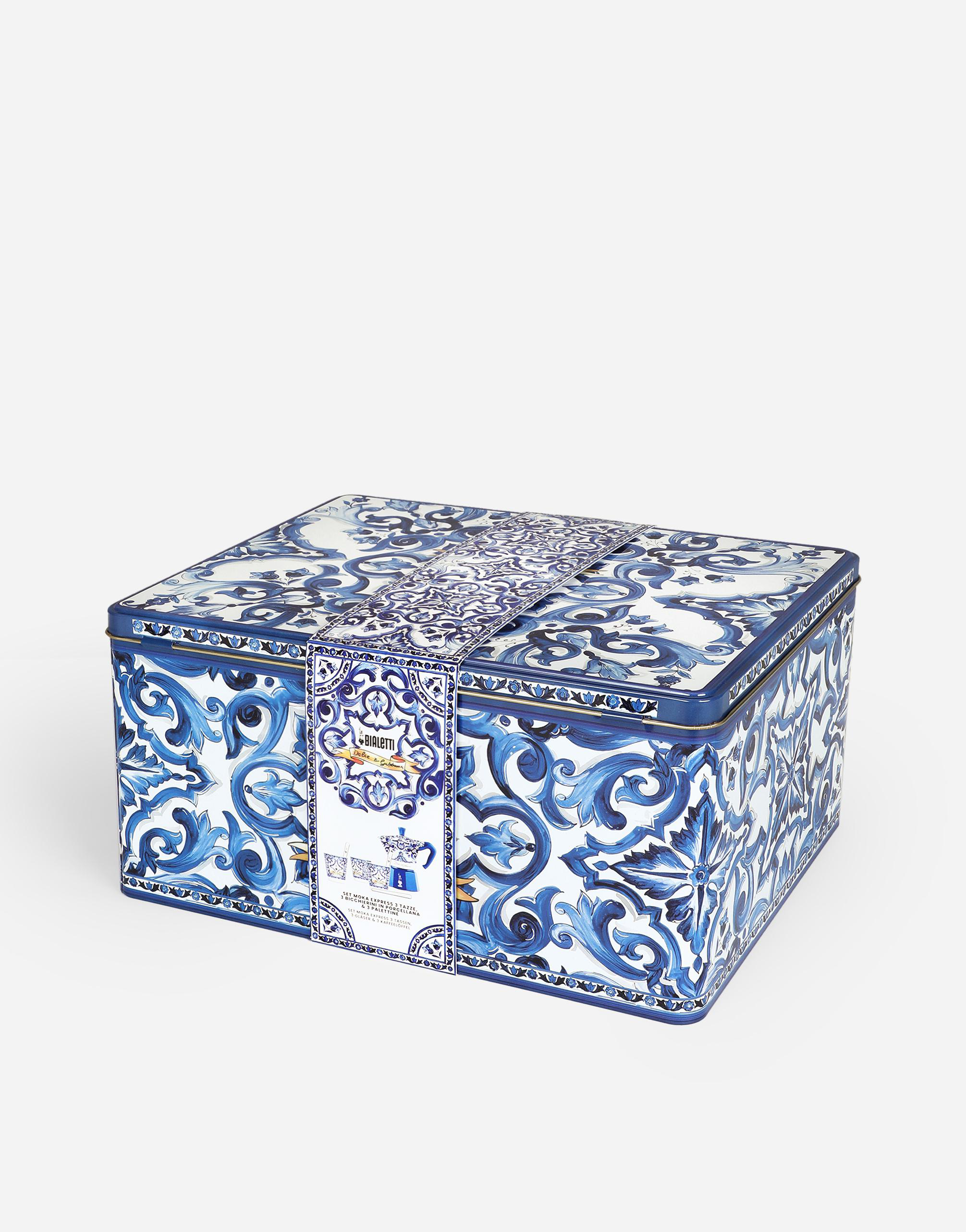 Eine quadratische Geschenkbox mit blau-weißem Blumendesign, mit einem Band gebunden.