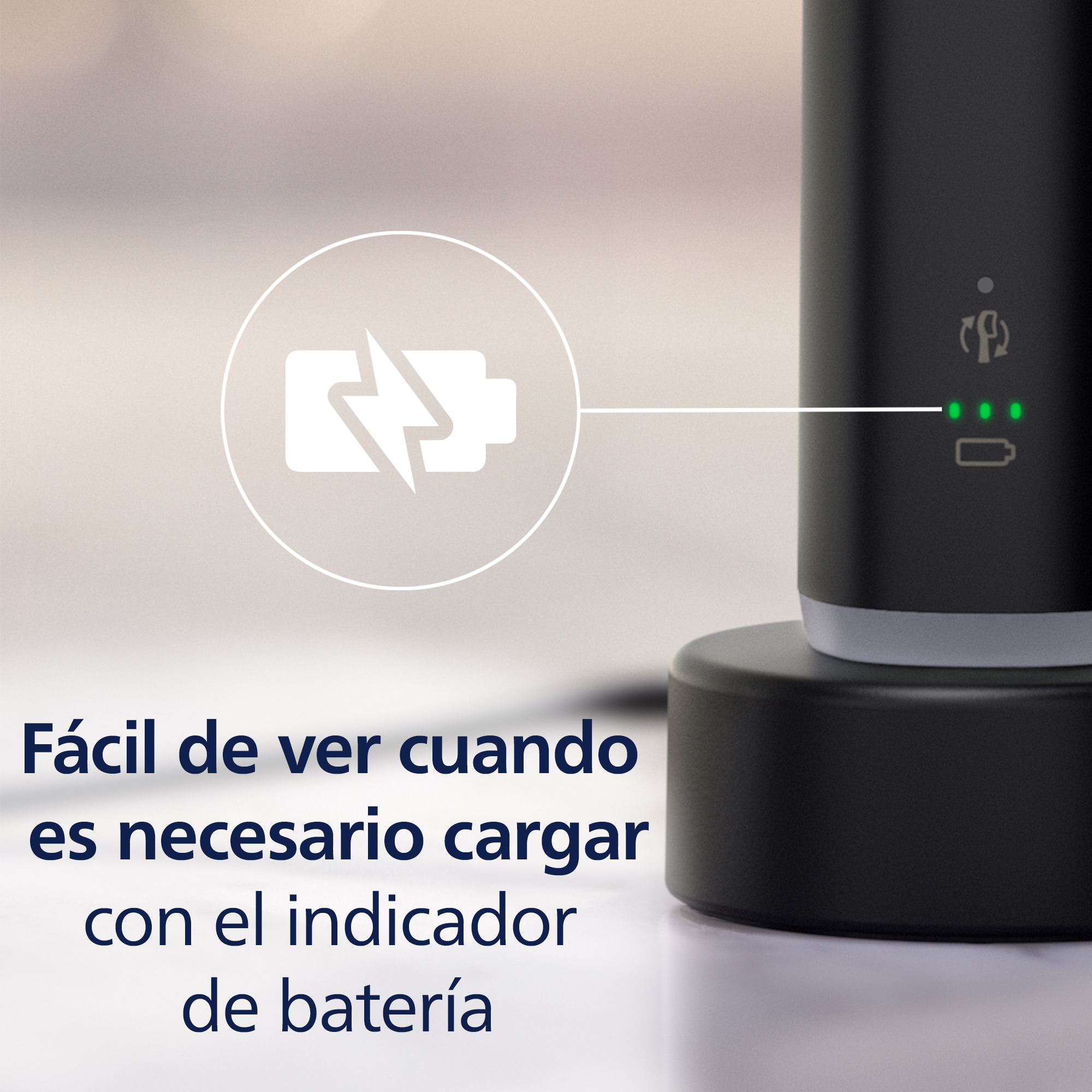 Dispositivo negro en un soporte con indicador de batería encendido. Texto en español.