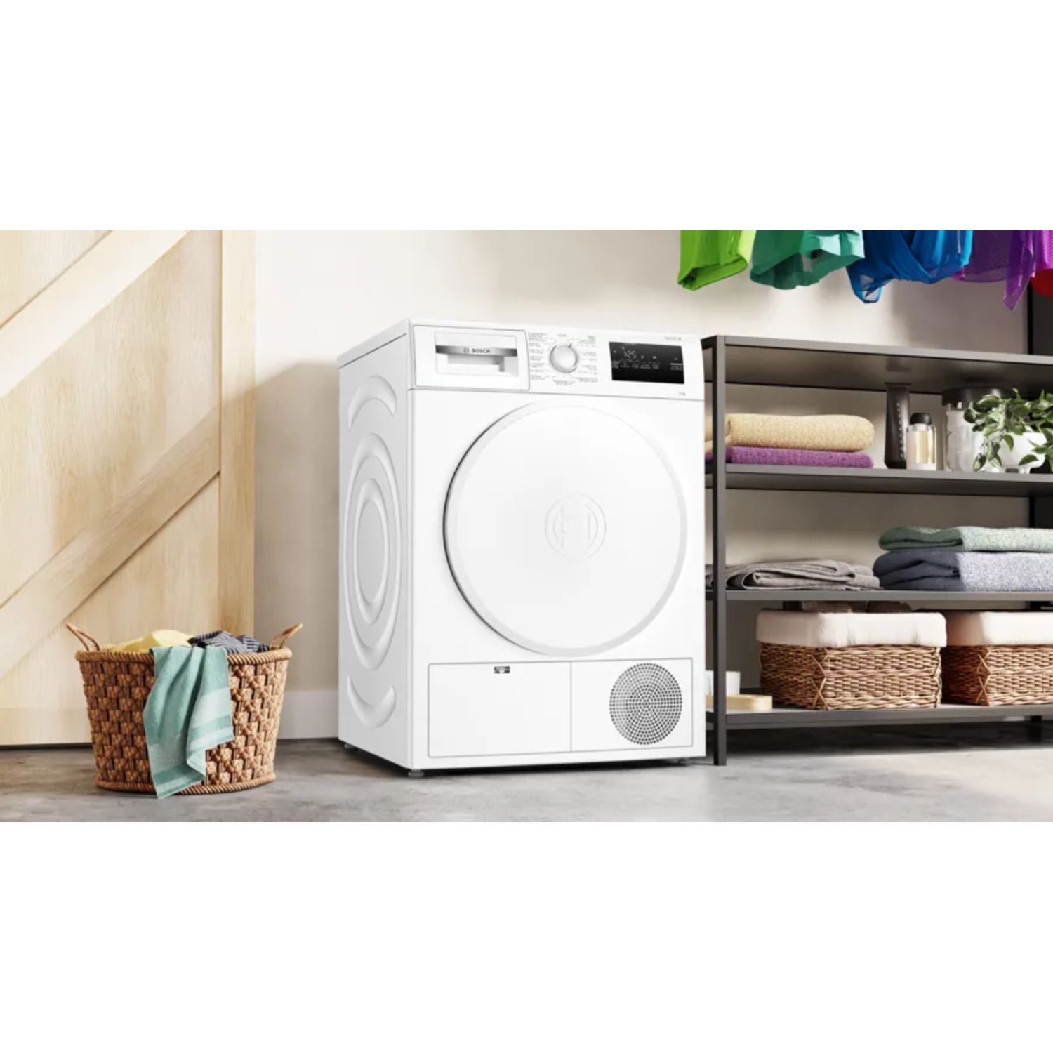 White washing machine and dryer. Clothes basket on the left, shelves with towels and baskets to the right.