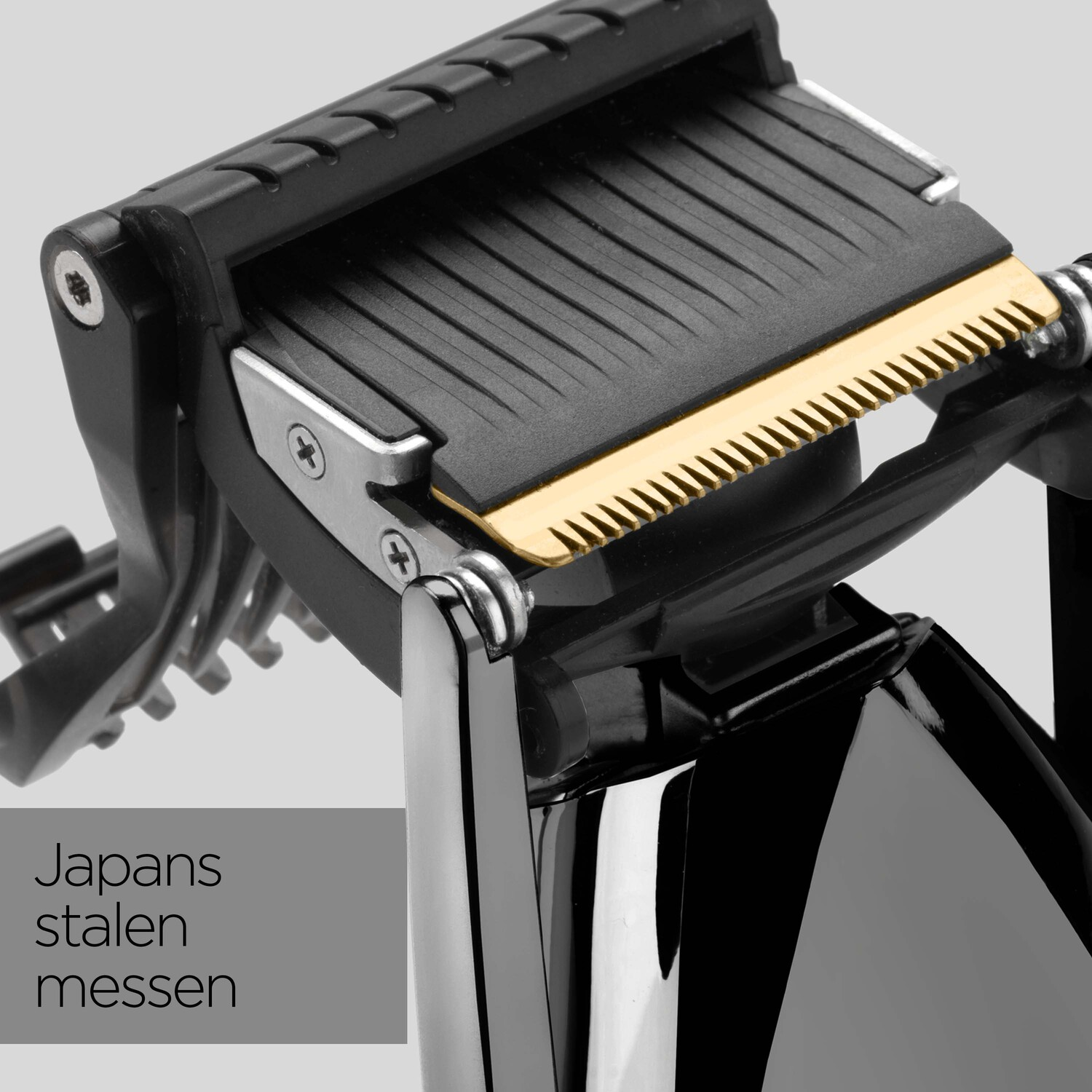 Close-up of a black and gold hair clipper head with Japanese text.