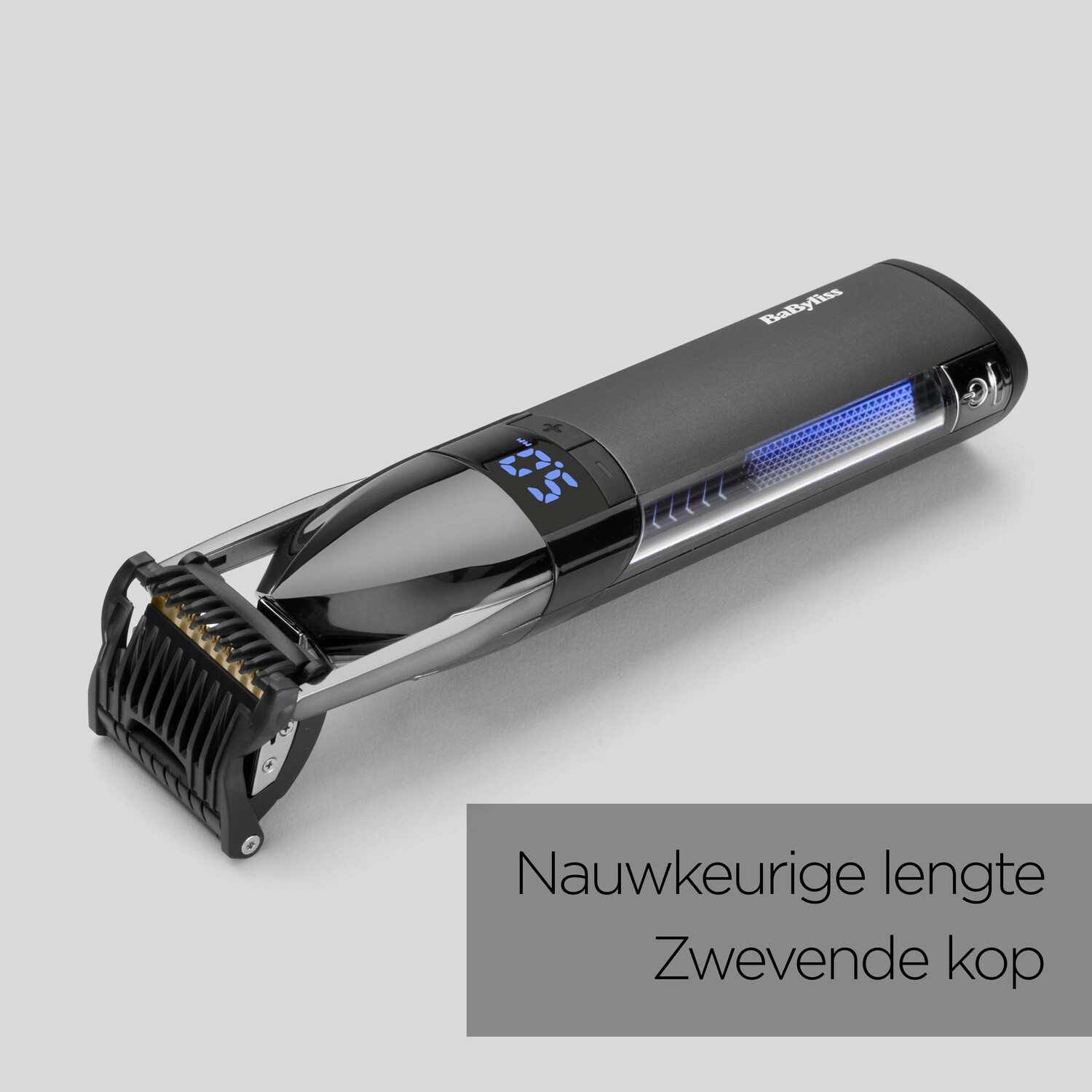 Black hair clipper with digital display and comb attachment.