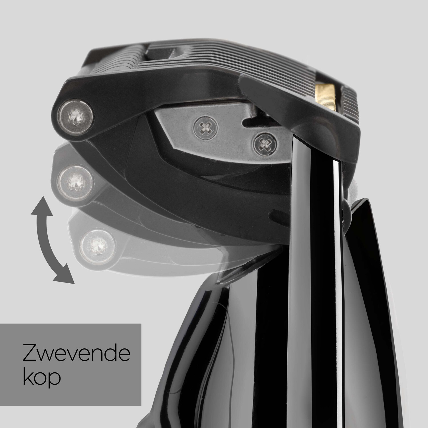 Close up of a black electric shaver showing the pivoting head. Gray background.