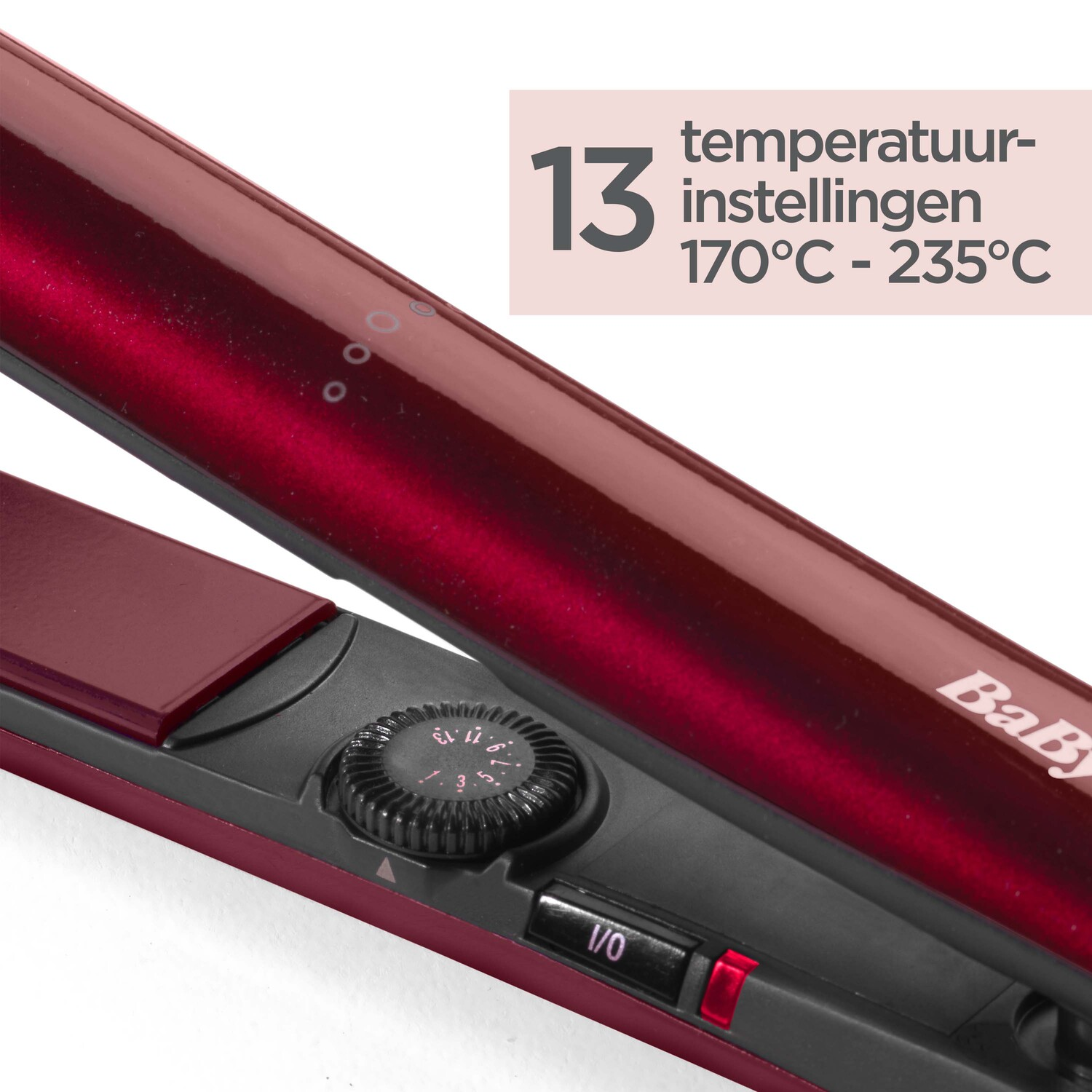 Red hair straightener with temperature settings displayed.