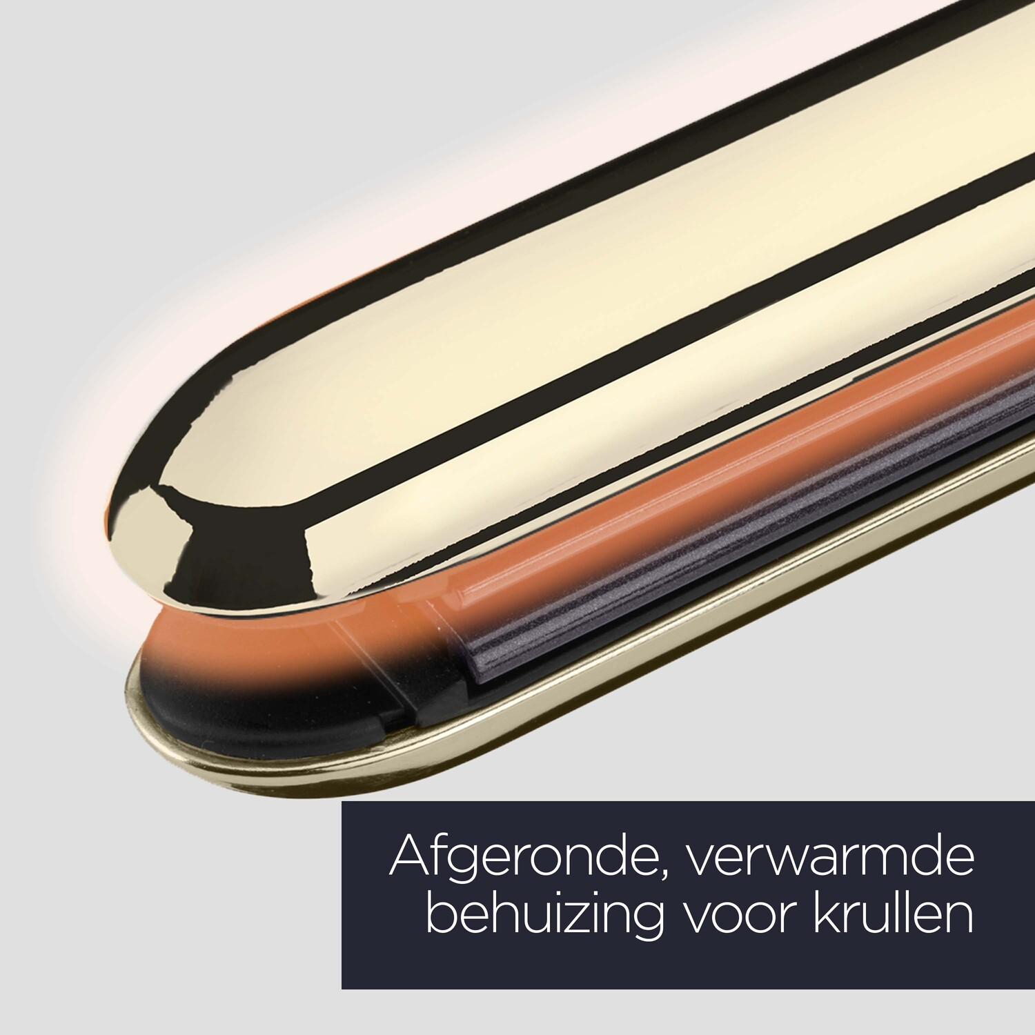 Golden hair straightener, showing the heated parts, on a light background.