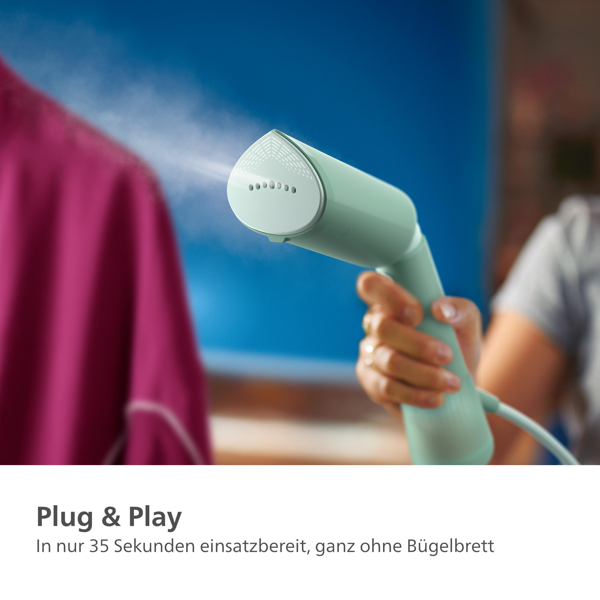 Ein türkisfarbener Hand-Dampfglätter für Kleidung, der ein rosa Hemd bedampft.