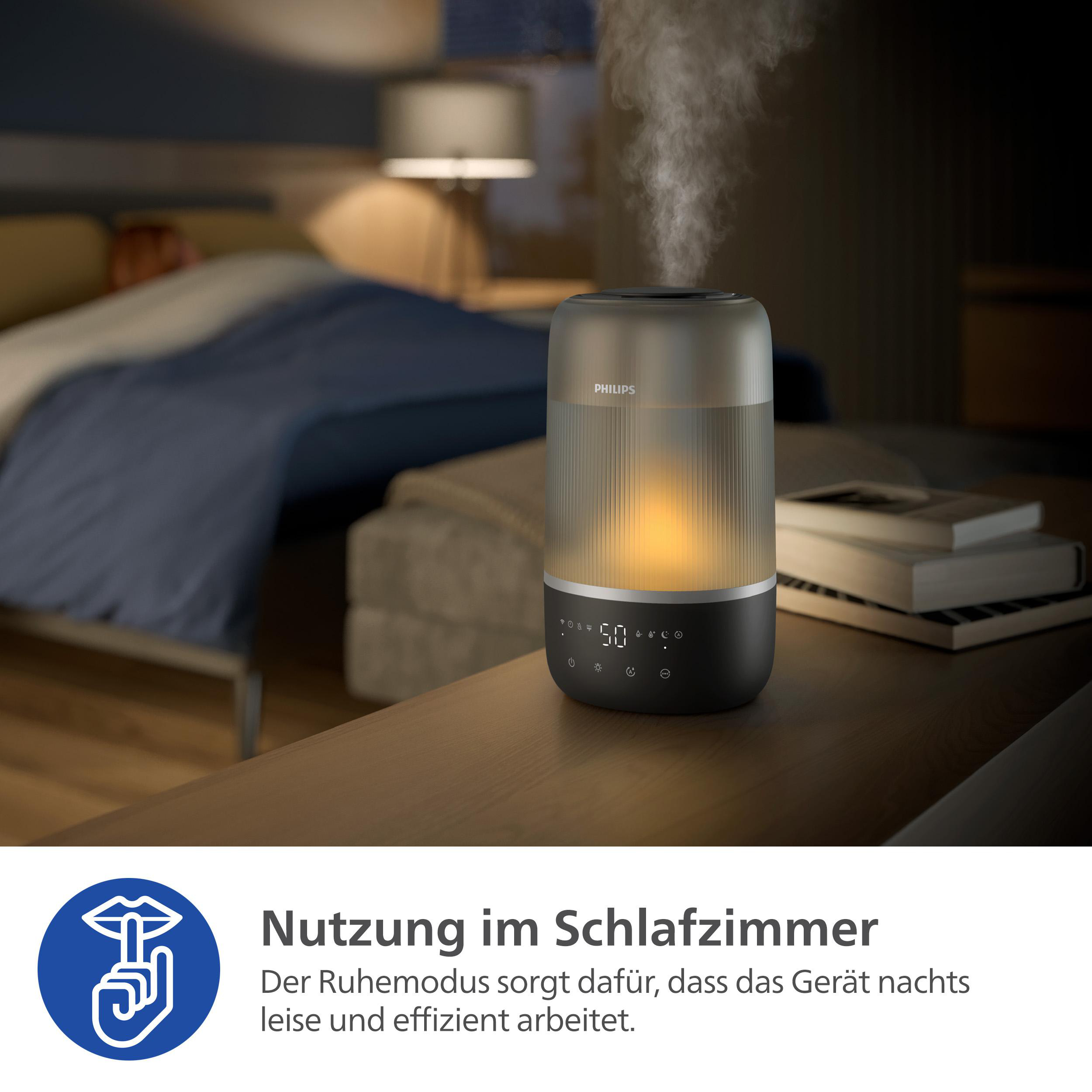 Ein schwarz-grauer Philips Luftbefeuchter mit glühendem Licht im Inneren.