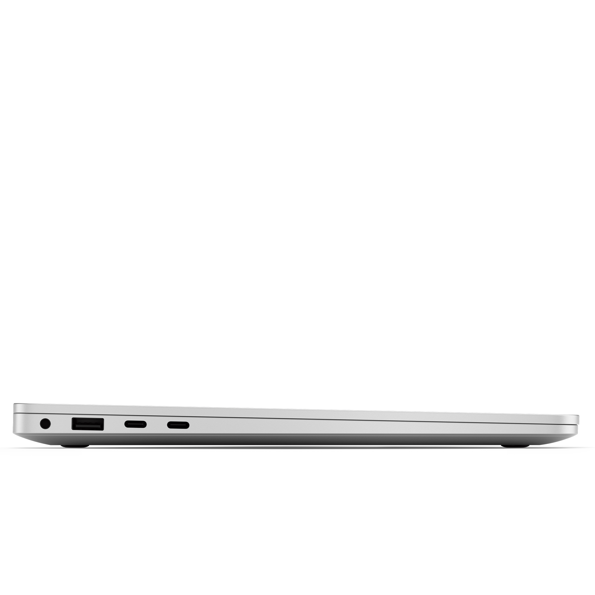 Ein silberner Laptop, von der Seite betrachtet, geschlossen, mit Anschlüssen.