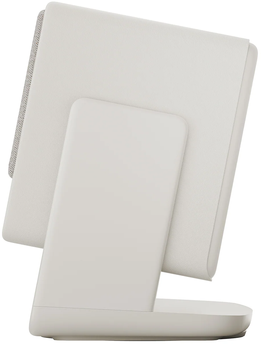 Un appareil blanc incliné sur une base blanche, peut-être un haut-parleur ou un appareil domestique intelligent.