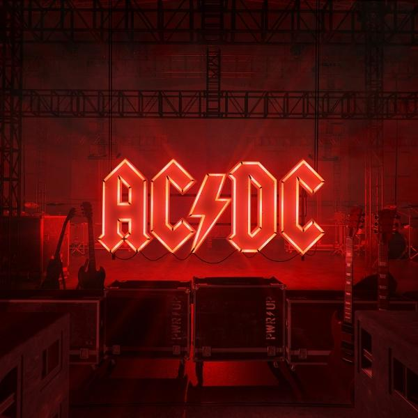 AC/DC logó piros neon stílusban. Színpadi beállítás gitárokkal és erősítőkkel a háttérben. Sötétvörös hangulat.