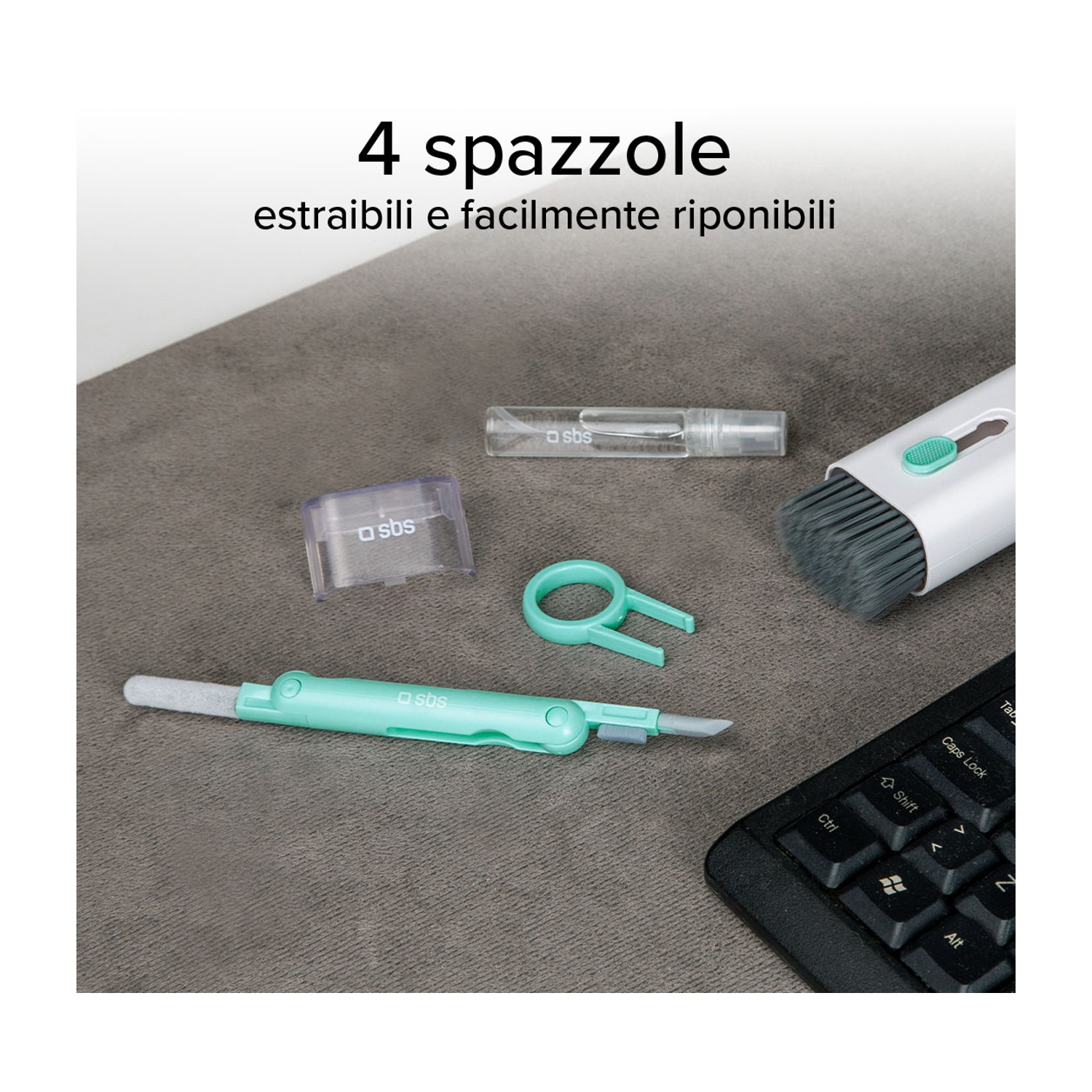 Set di 4 spazzole e strumenti per la pulizia su una superficie grigia. Tastiera sullo sfondo.