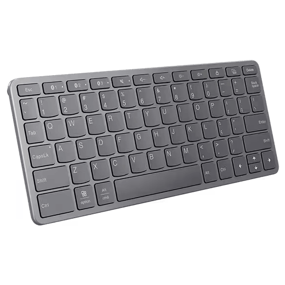 Un teclado gris con teclas sobre un fondo oscuro.