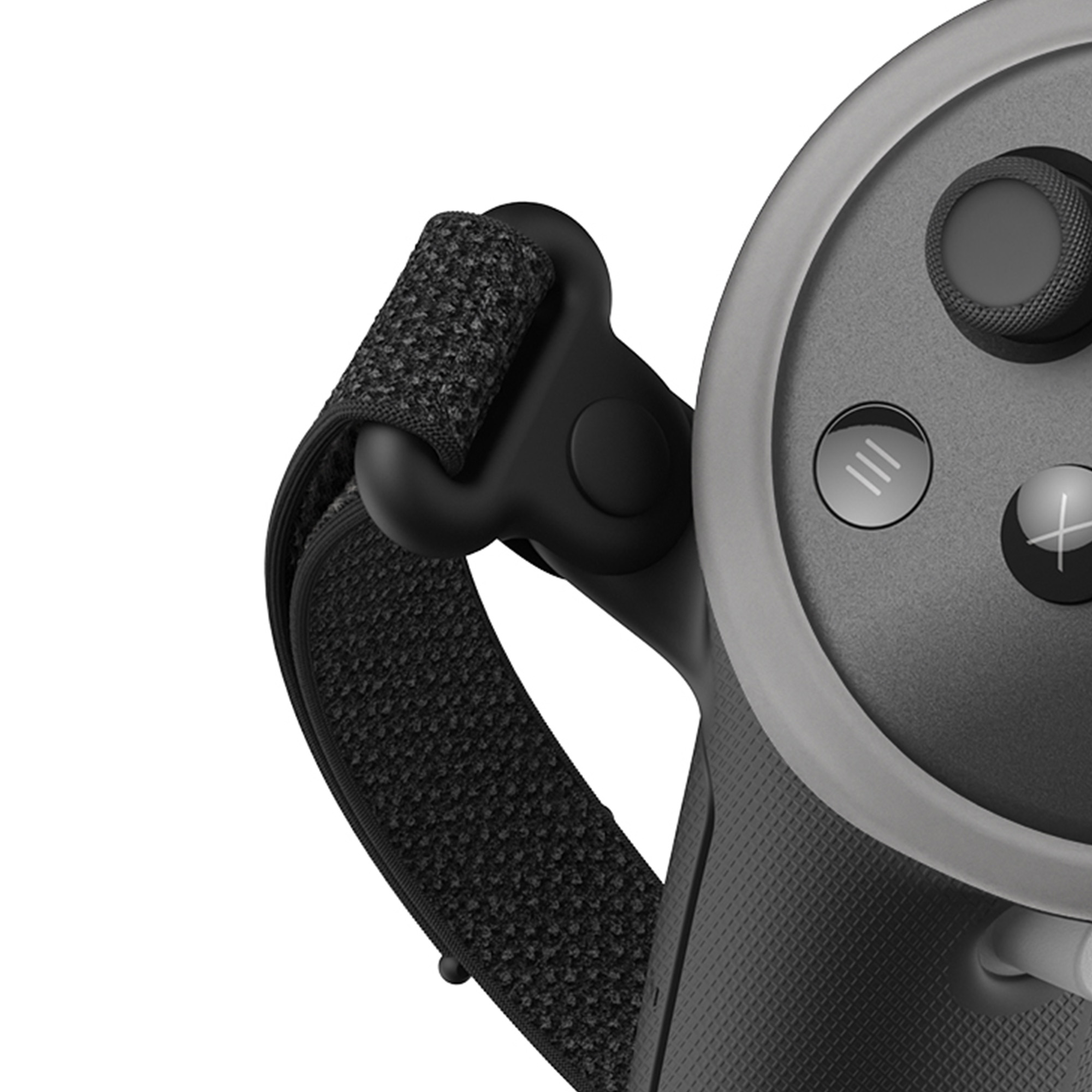 VR-Controller mit schwarzem Riemen, grauen und schwarzen Knöpfen. Weißer Hintergrund.