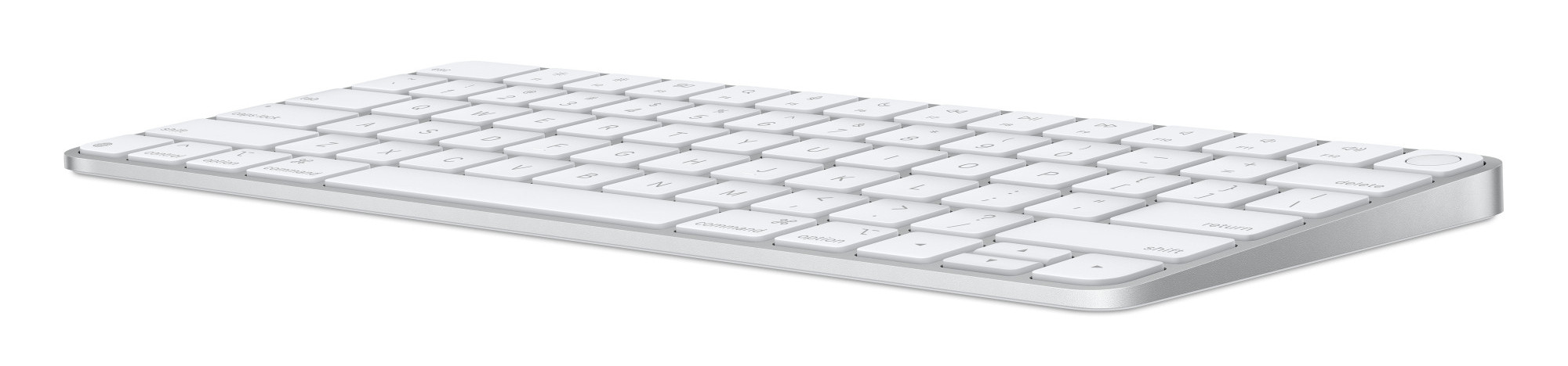 Biała klawiatura Apple na białej powierzchni, pokazująca klawisze i srebrną krawędź.