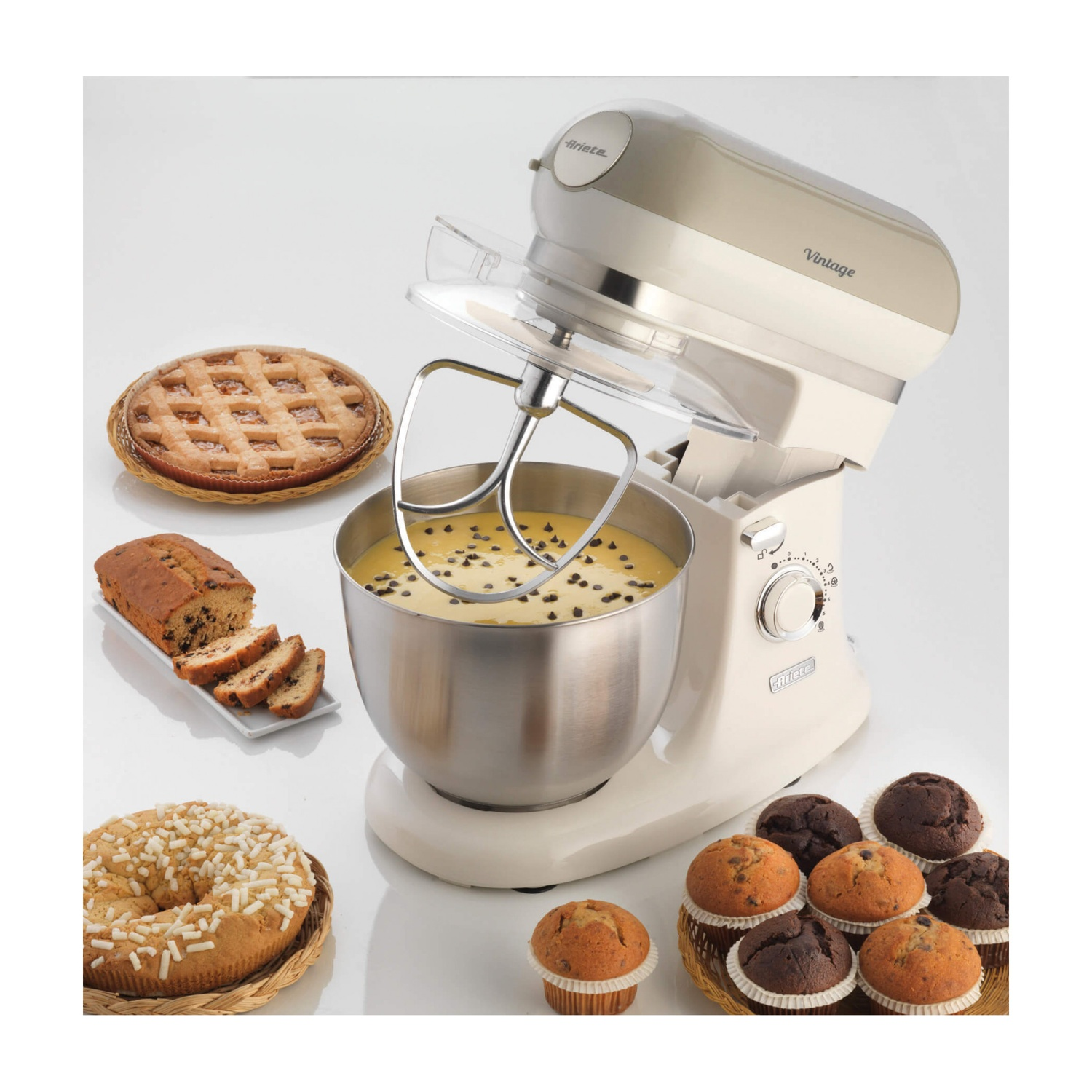 Impastatrice color crema con vari prodotti da forno disposti attorno.