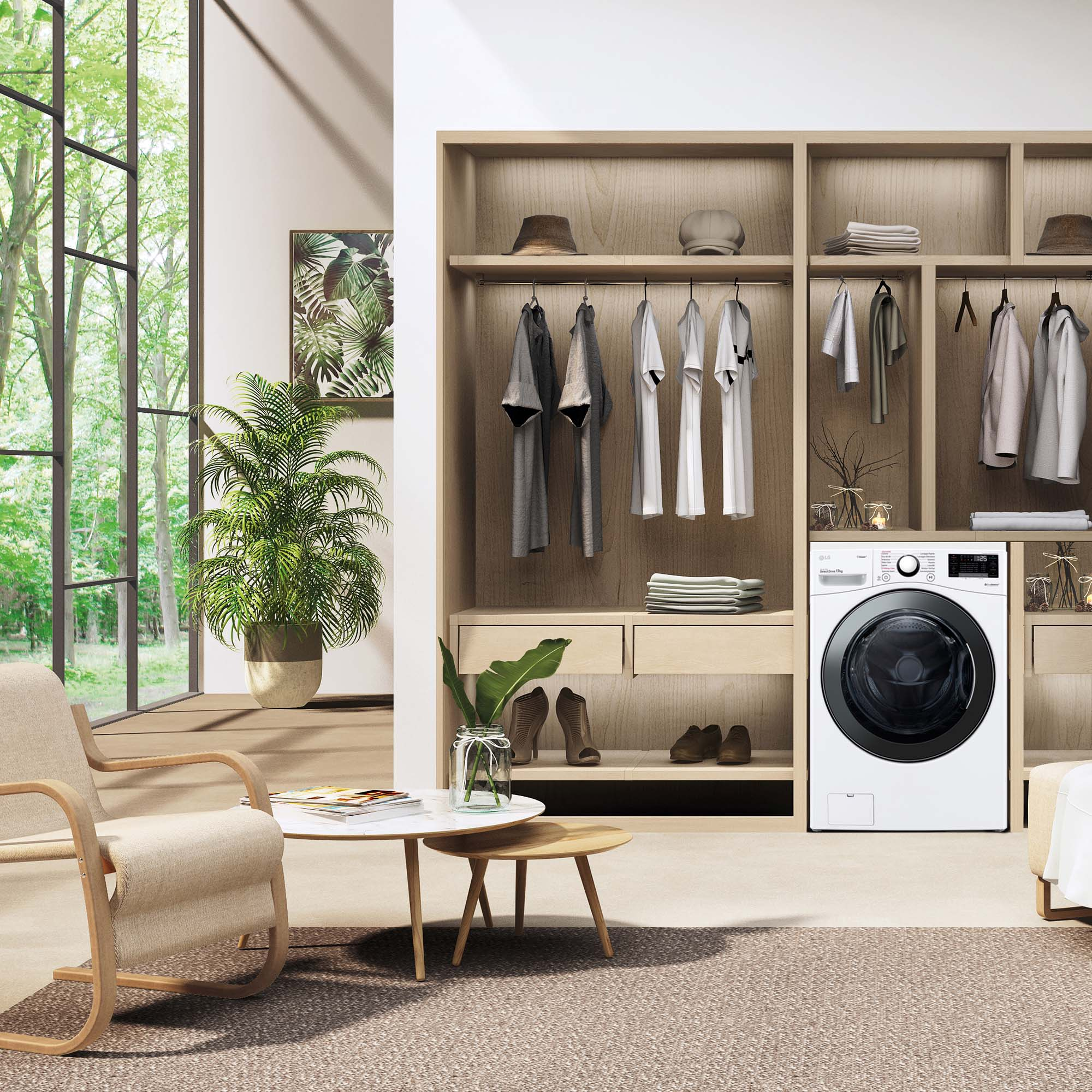 Un lavadero con lavadora, ropa y plantas. Una gran ventana proporciona luz natural.