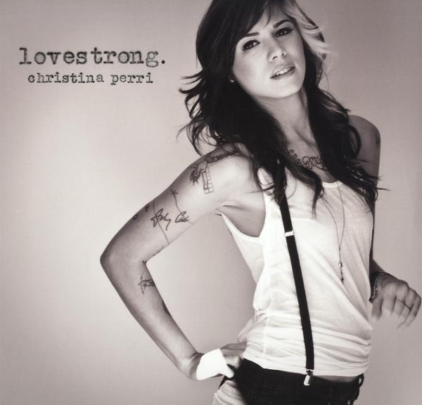 Album borítója egy nővel, topban, nadrágtartóval és tetoválásokkal, az album címével.