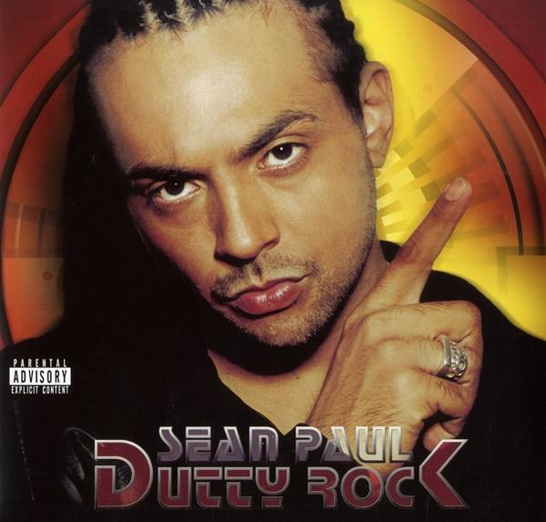 A 'Dutty Rock' album borítója Sean Paul-lal. A nézőre mutat.