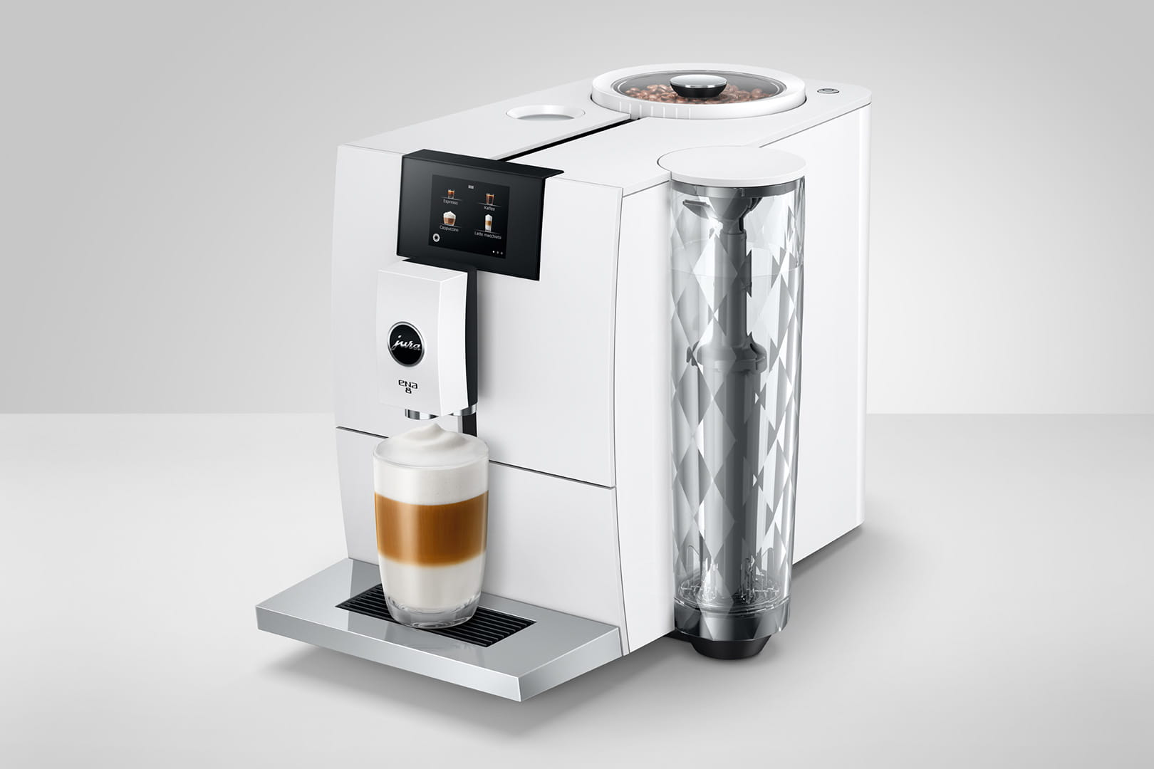 Macchina da caffè bianca e argento con un bicchiere di caffè.