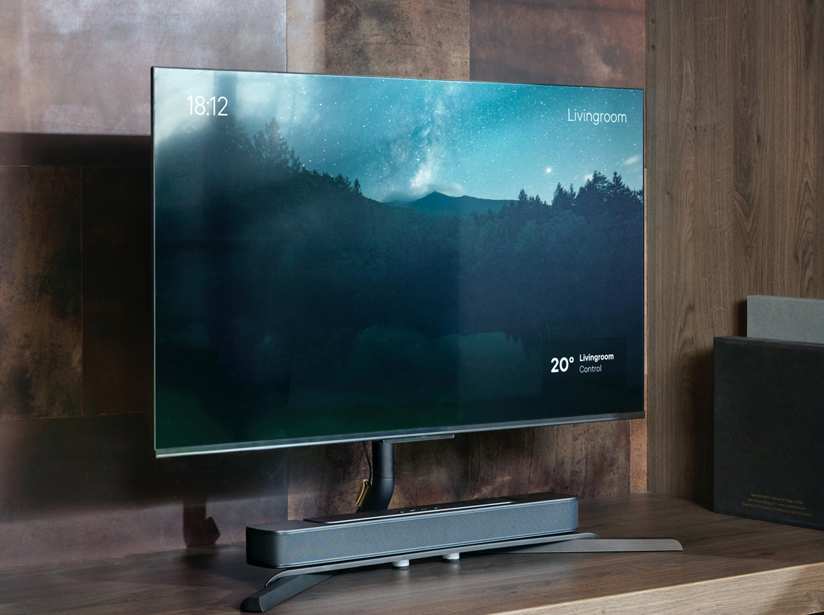 Ein moderner Fernseher, der eine Nachtszene anzeigt, und eine Soundbar darunter.