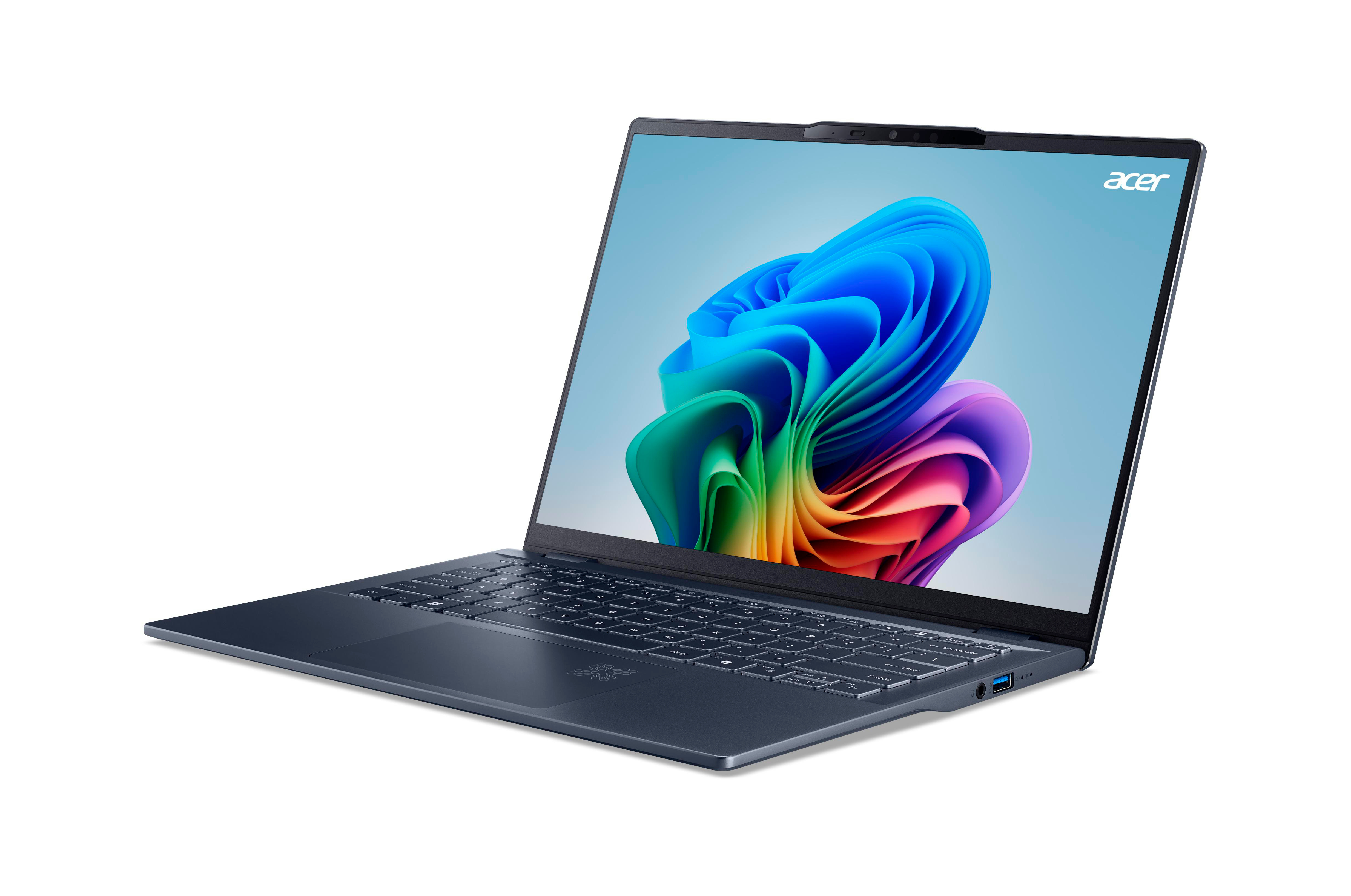 Ein marineblauer Laptop, der auf einer weißen Oberfläche geöffnet ist, mit einem lebendigen, farbenfrohen Hintergrund auf dem Bildschirm.