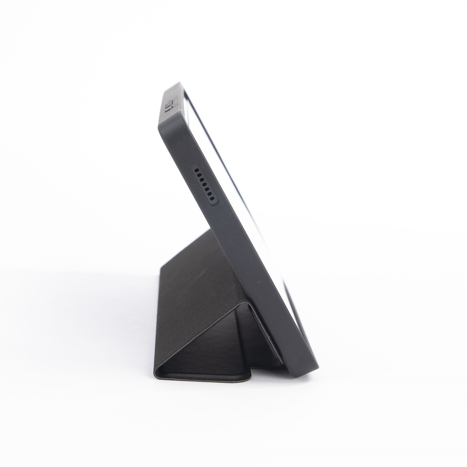 Tablet with a black cover. The tablet is on the cover in a standing position, on a white surface.
