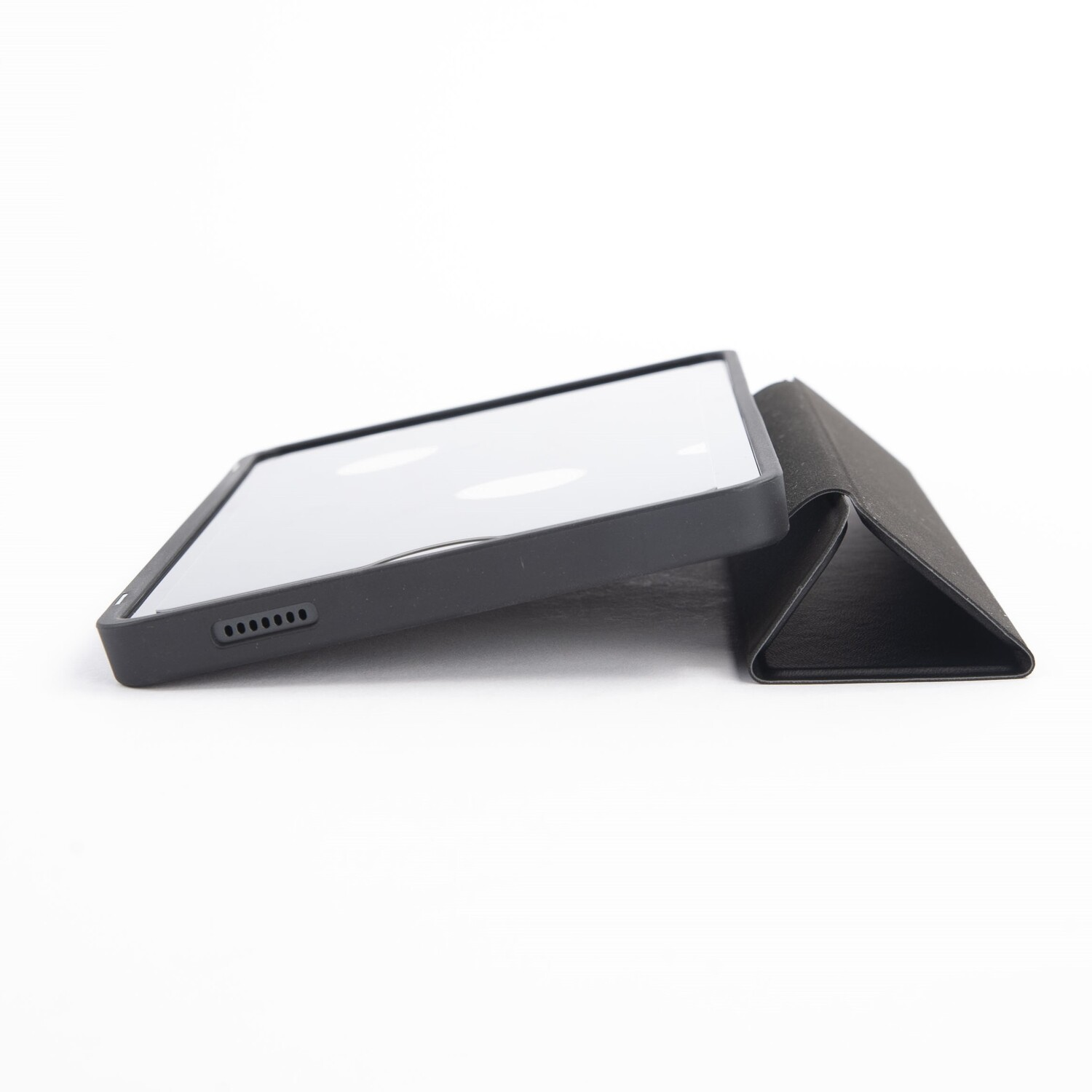 A black tablet in a case and stand. The tablet is on its side, the stand is folded next to it.