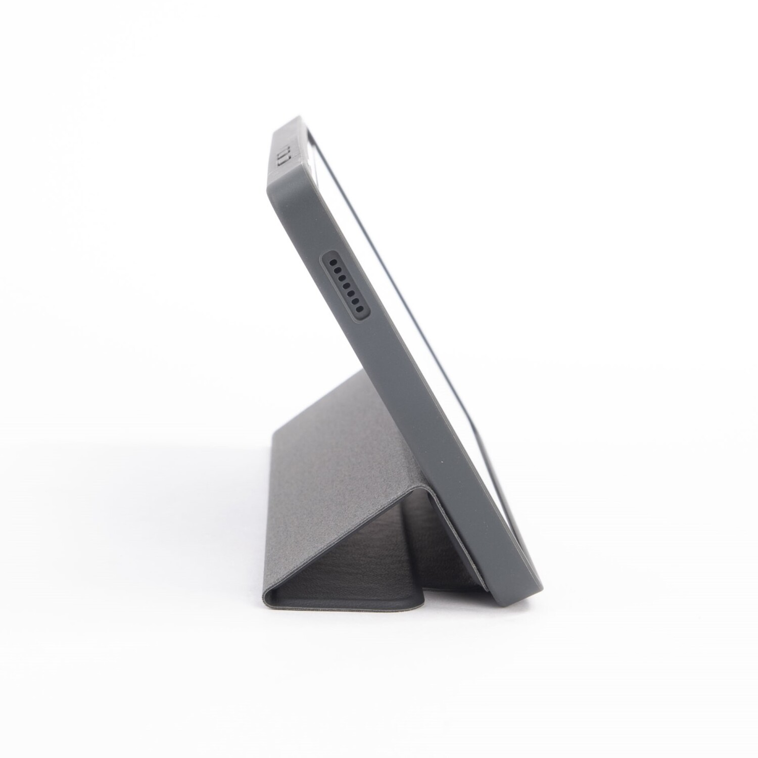 Tablet in a dark gray case, angled against a white surface.