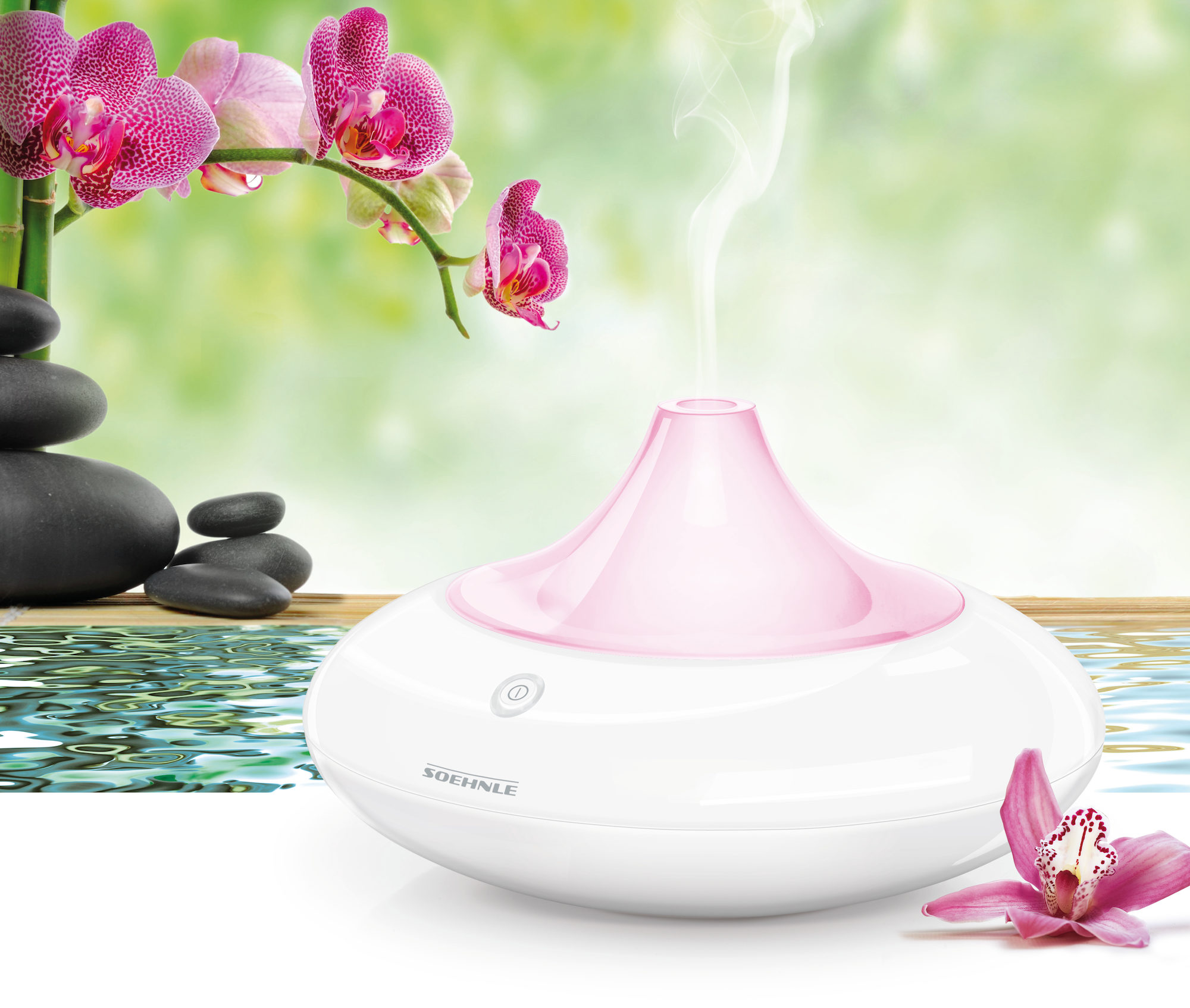 Biało-różowy dyfuzor zapachów z kwiatem, bambusem i czarnymi kamieniami.