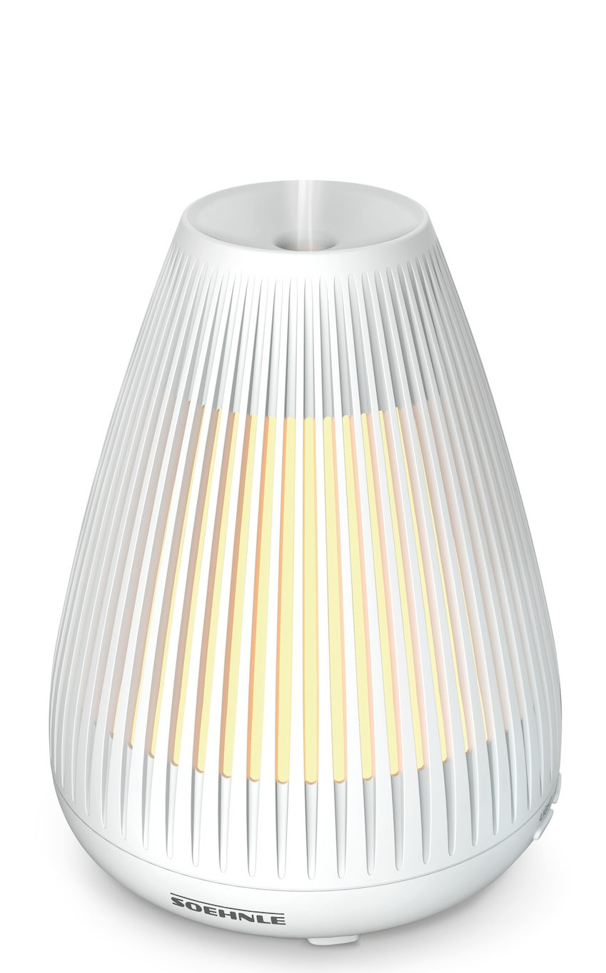 Biały dyfuzor olejków eterycznych z żebrowanym wzorem i żółtą poświatą w środku.