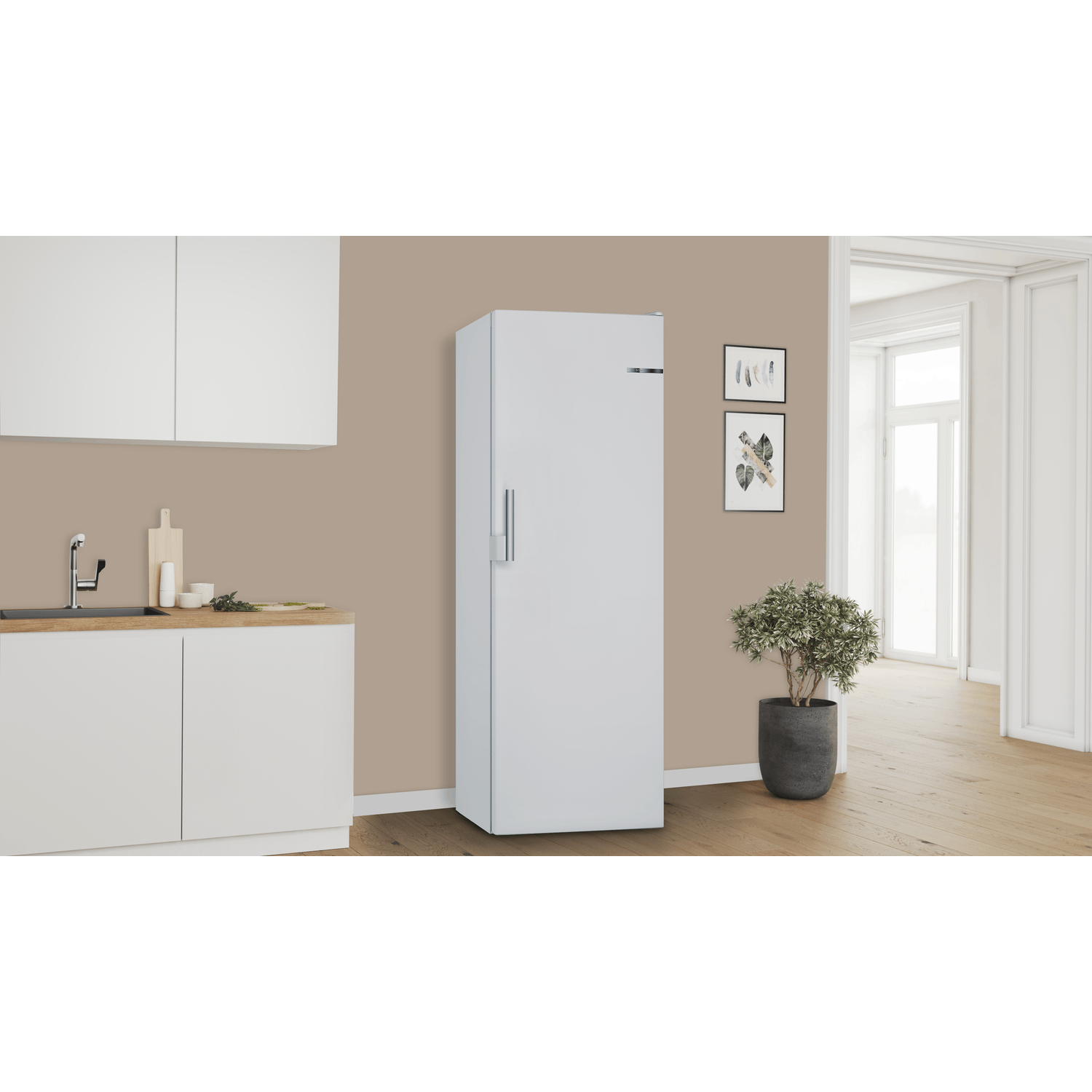 A white refrigerator in a kitchen setting with light walls.