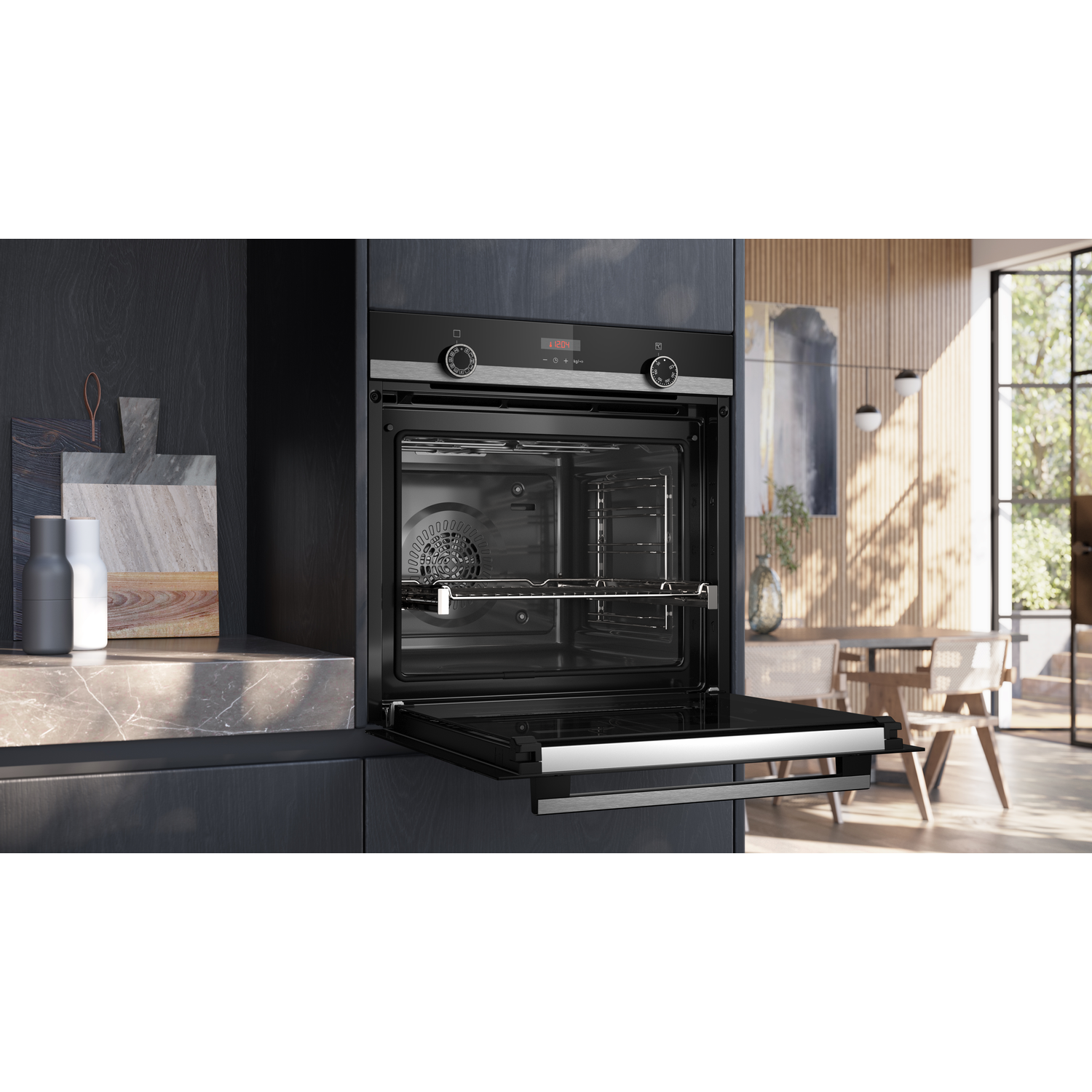 Open oven in a kitchen. Oven door is open. Kitchen and dining area in the background.