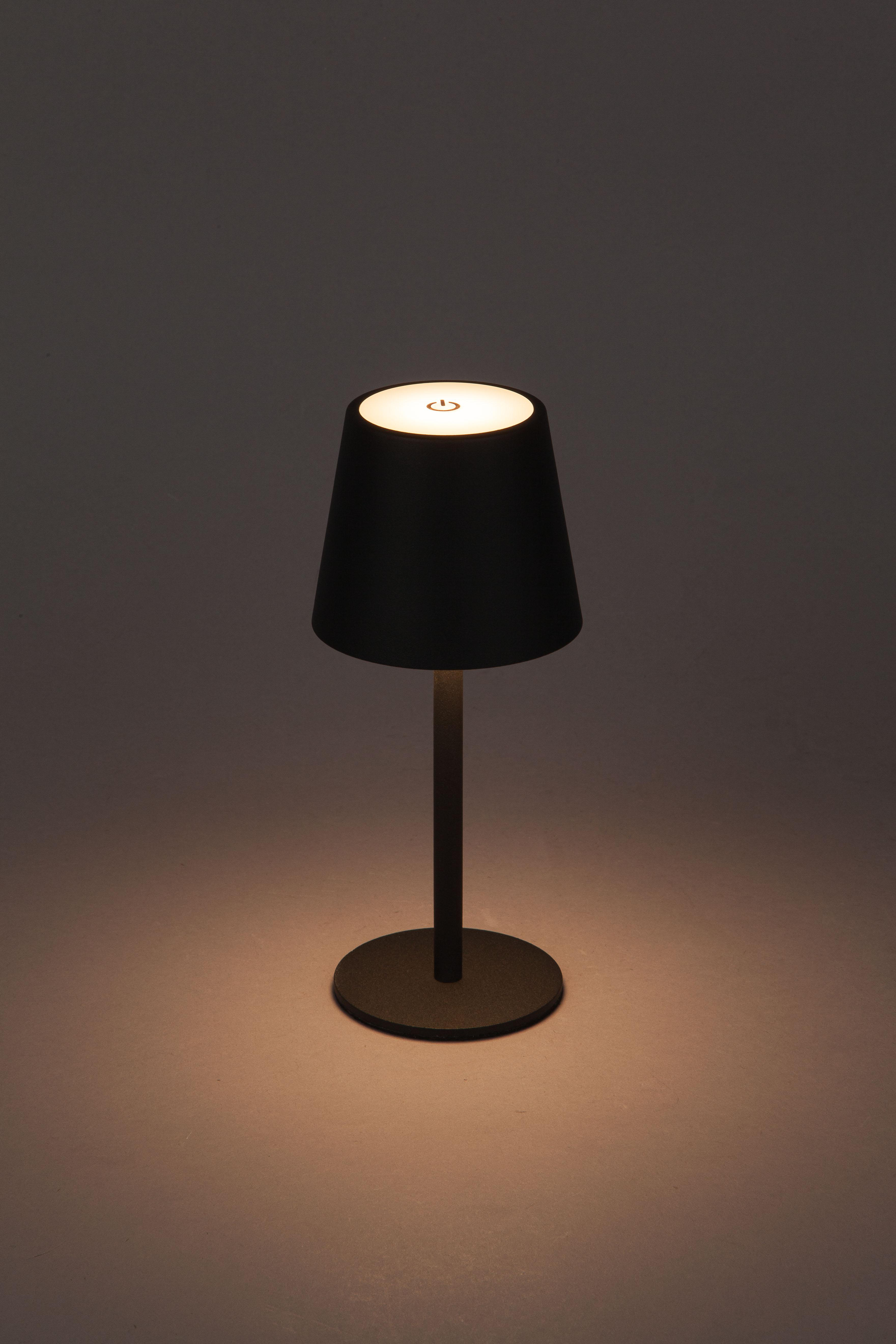 Schwarze Tischlampe auf grauem Hintergrund mit beleuchteter Oberseite.