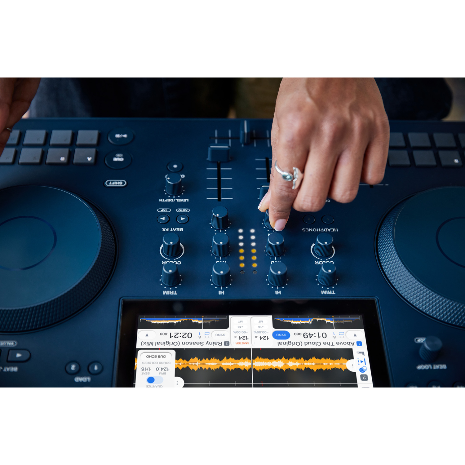 DJ-controller met handen die knoppen aanpassen. Scherm toont golfvorm en trackinfo.