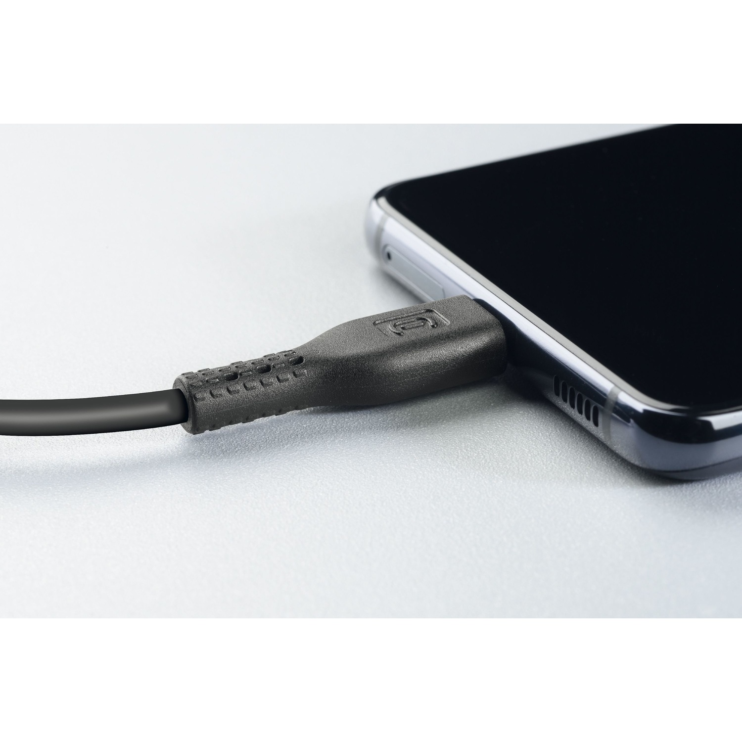 Primo piano di un cavo di ricarica nero collegato a uno smartphone.