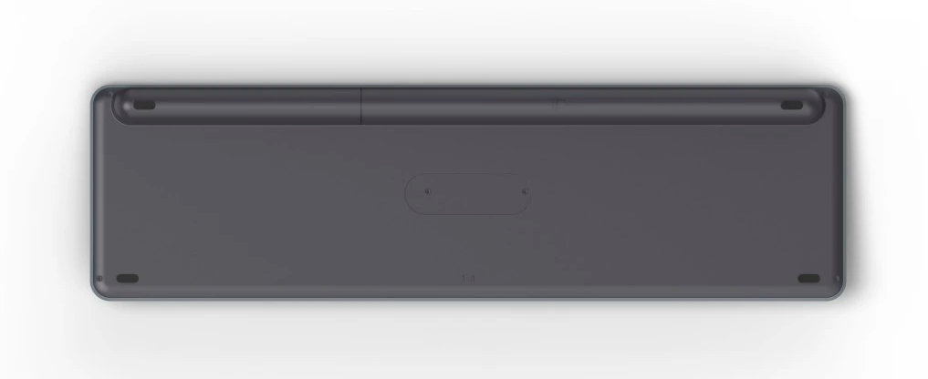 Widok od spodu szarej klawiatury, biała powierzchnia.