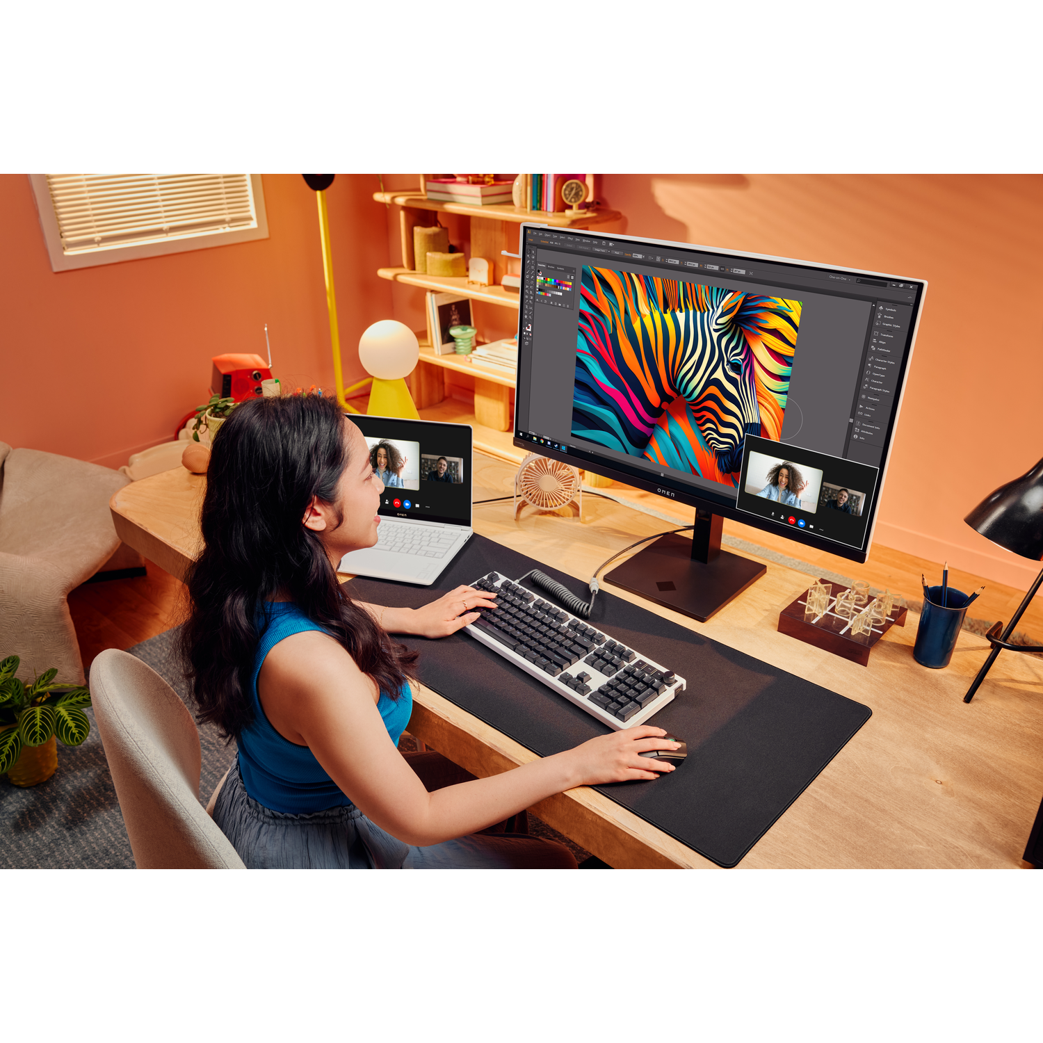 Woman in front of a computer, screen with a zebra picture.