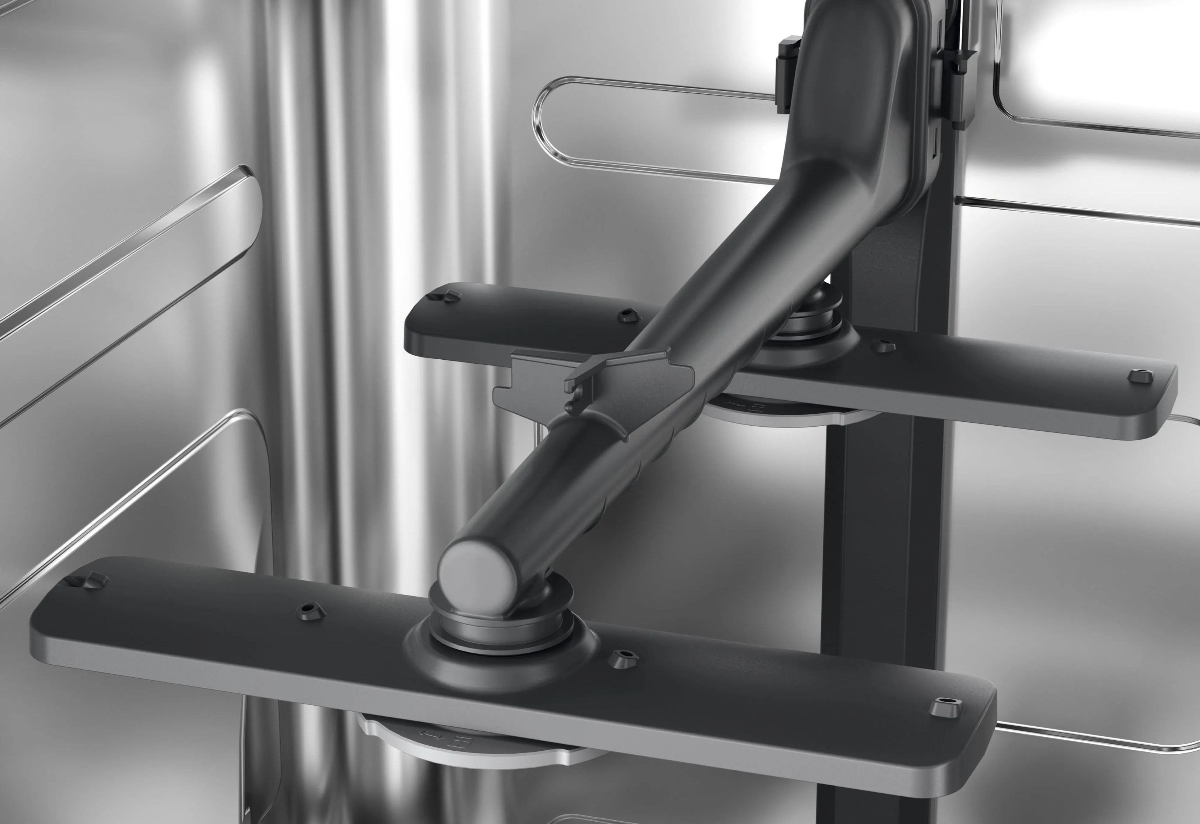 Wnętrze zmywarki, pokazujące ramiona spryskujące i stojaki. Metaliczny szary kolor.