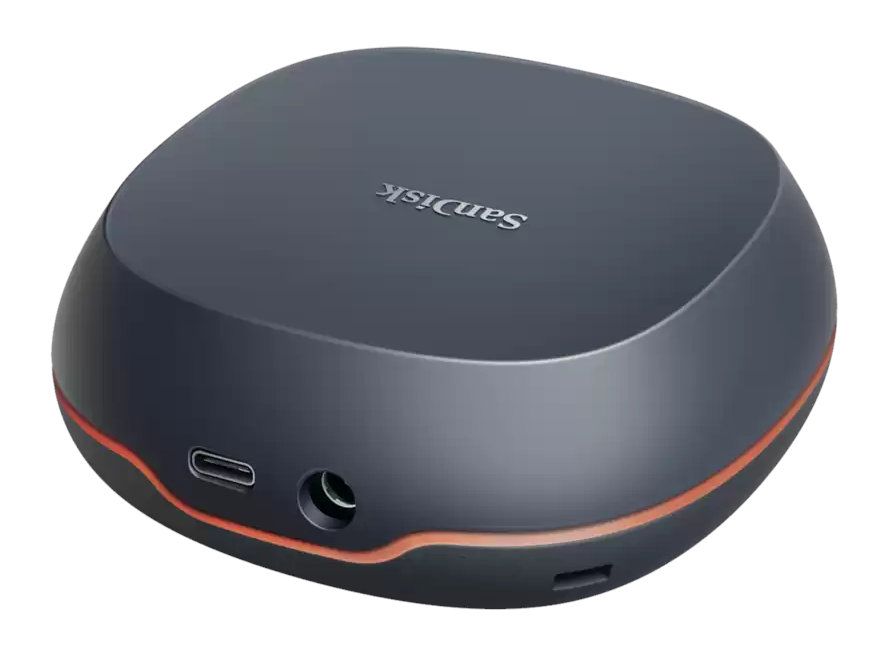 Czarny i pomarańczowy zewnętrzny dysk twardy SanDisk. Zaokrąglony kształt z portami z boku.