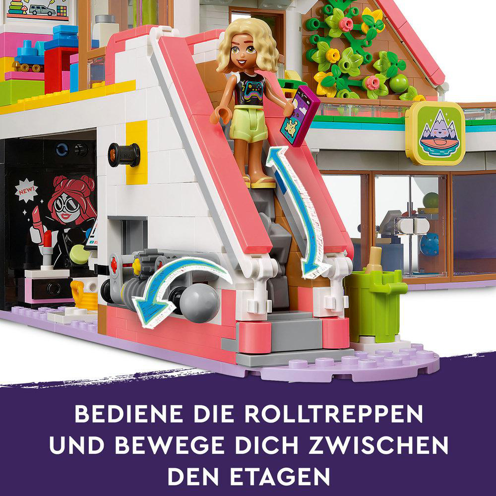 Lego-Set mit Mädchenfigur, rosa Rutsche und dem Text: 'BEDIENE DIE ROLLTREPPEN'.
