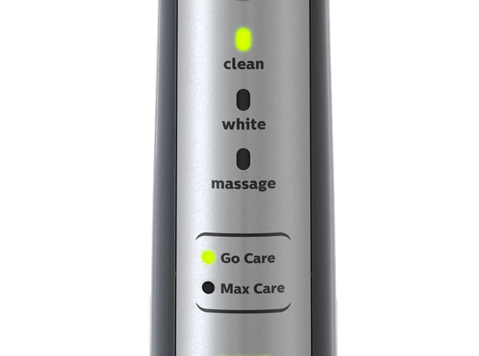 Zbliżenie panelu sterowania szczoteczki elektrycznej. Pokazuje tryby czyszczenia z zielonymi światłami.