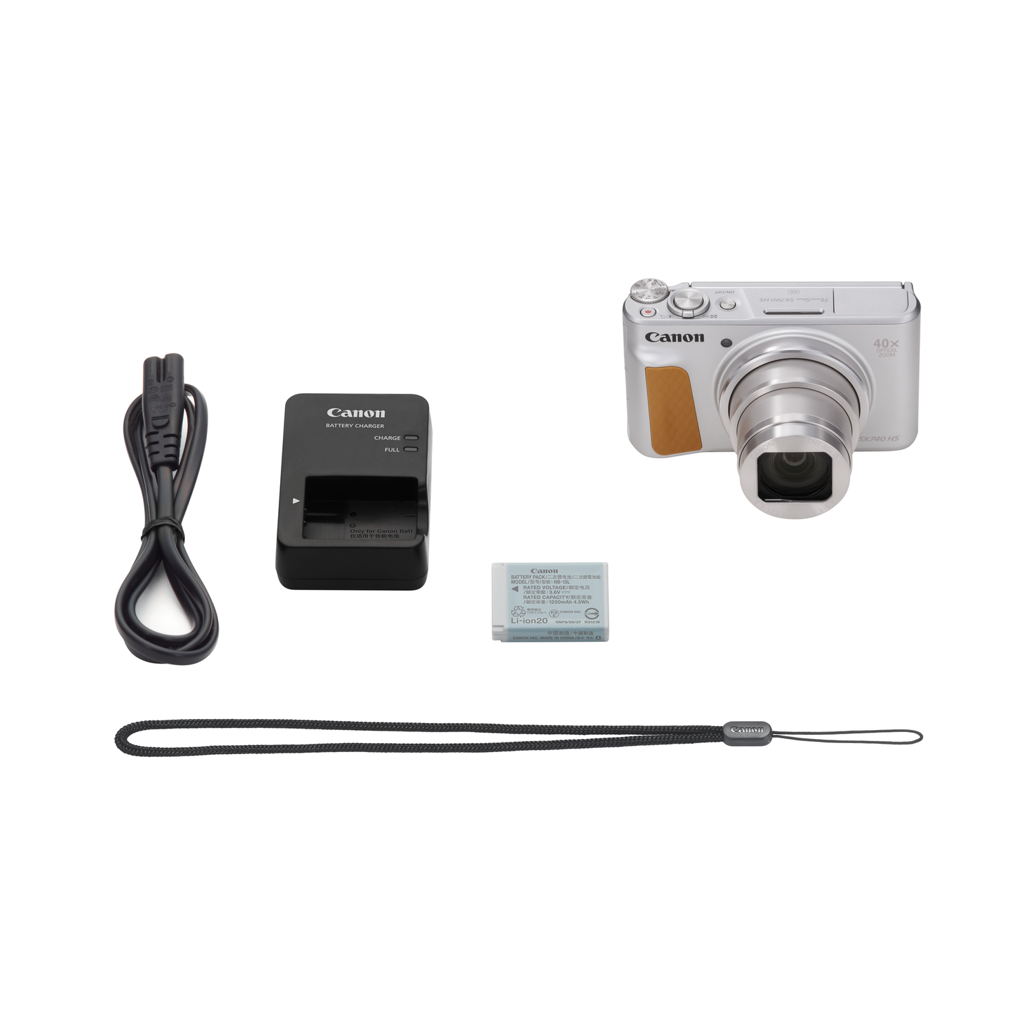 A Canon camera and accessories: charger, battery, wrist strap, and a cable.