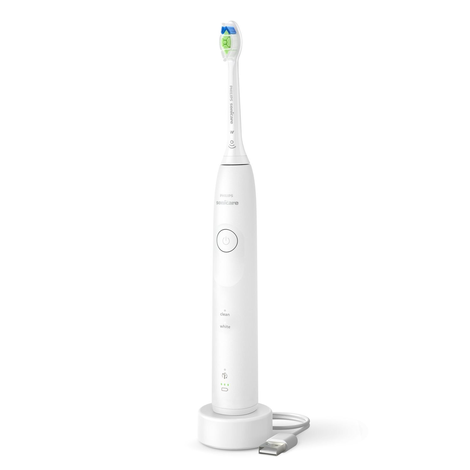 Une brosse à dents électrique blanche sur une base de chargement avec un câble USB.