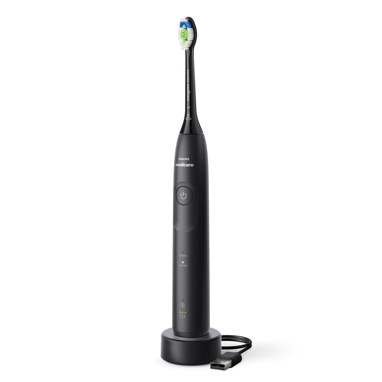 A black electric toothbrush with a charging base and a USB cable.