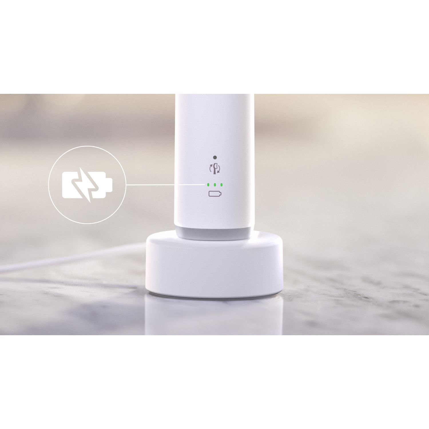 Chargeur de brosse à dents blanc avec indicateur de charge, sur marbre.
